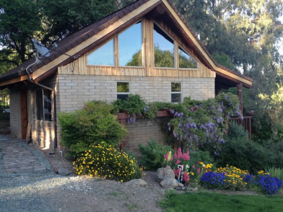 Outside shot of the cabin- those are spring/early summer flowers