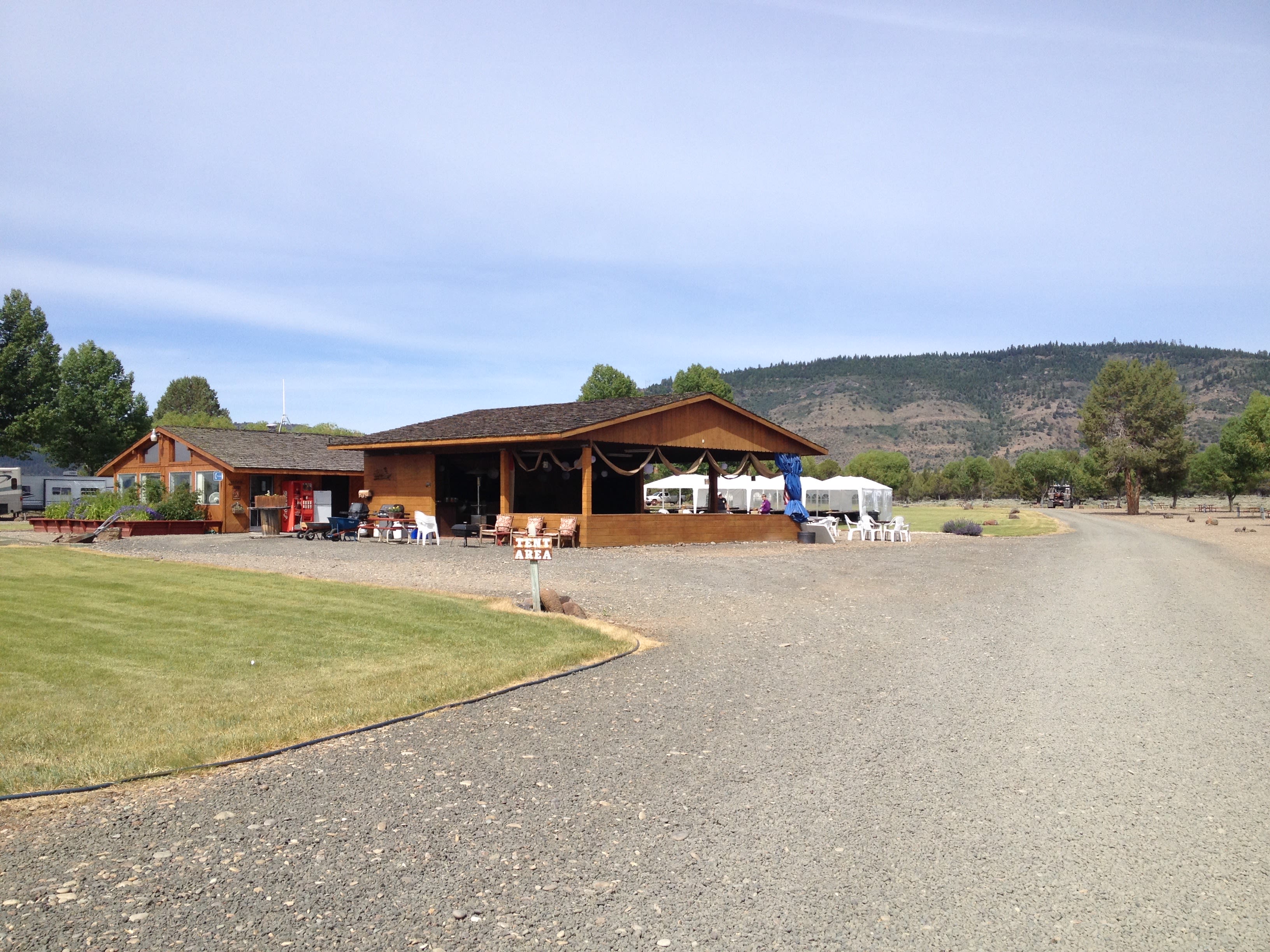 Open air pavilion with tables and chairs to eat and mingle.