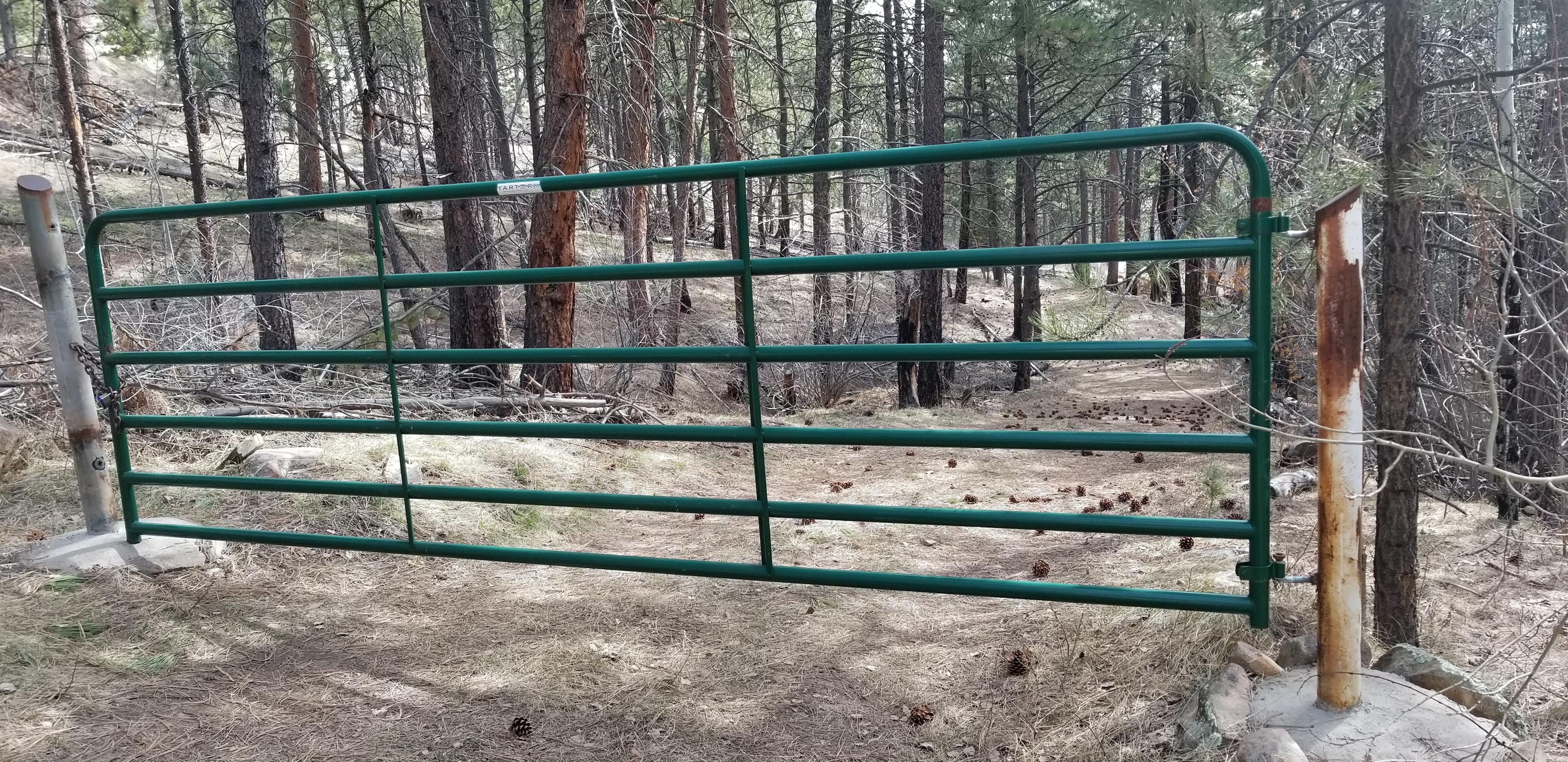 Gate at the top of the driveway for entry to the cabin.