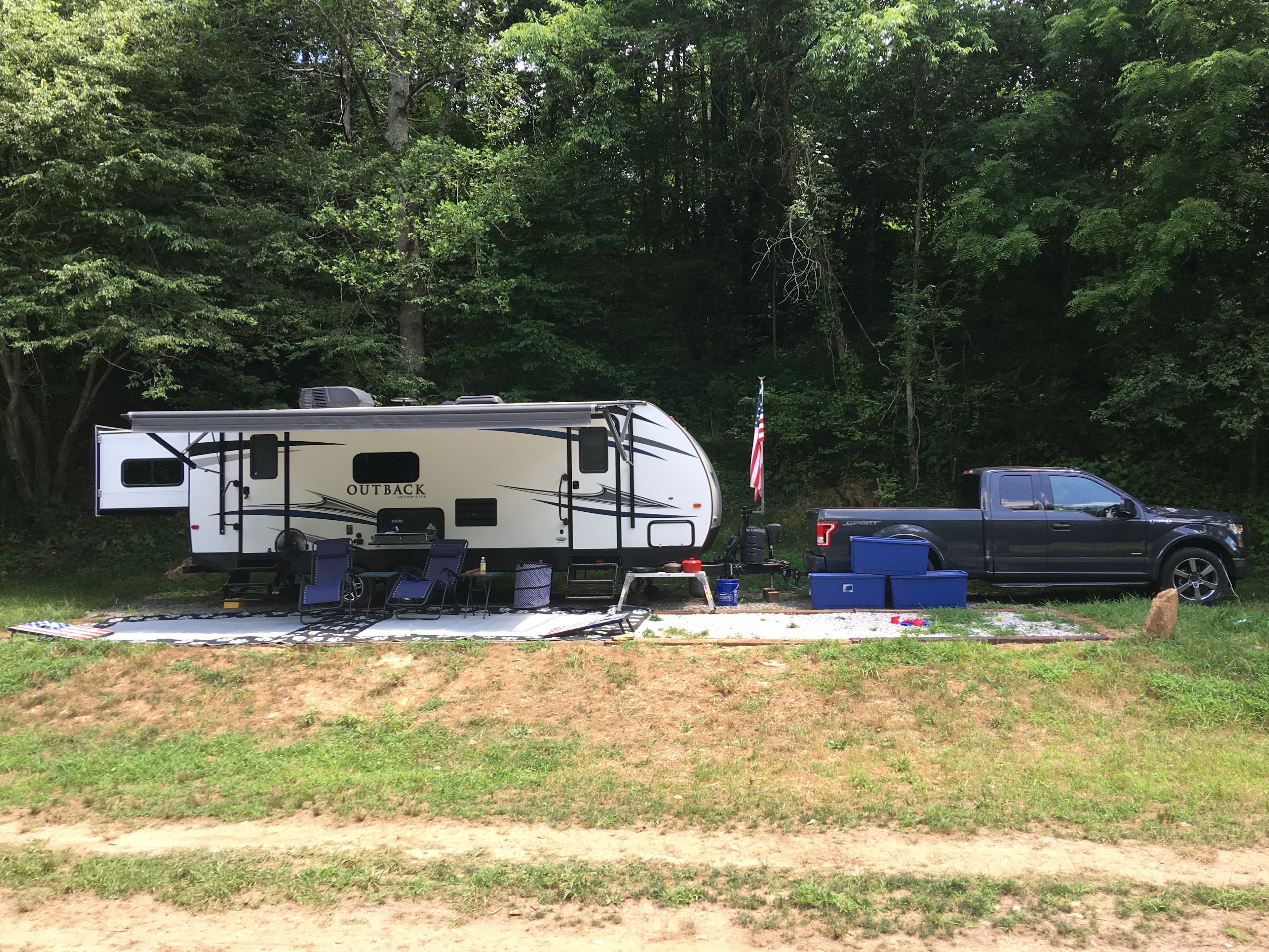 Large gravel site under camper and awing. We are 50 feet with truck and it fit all. 
