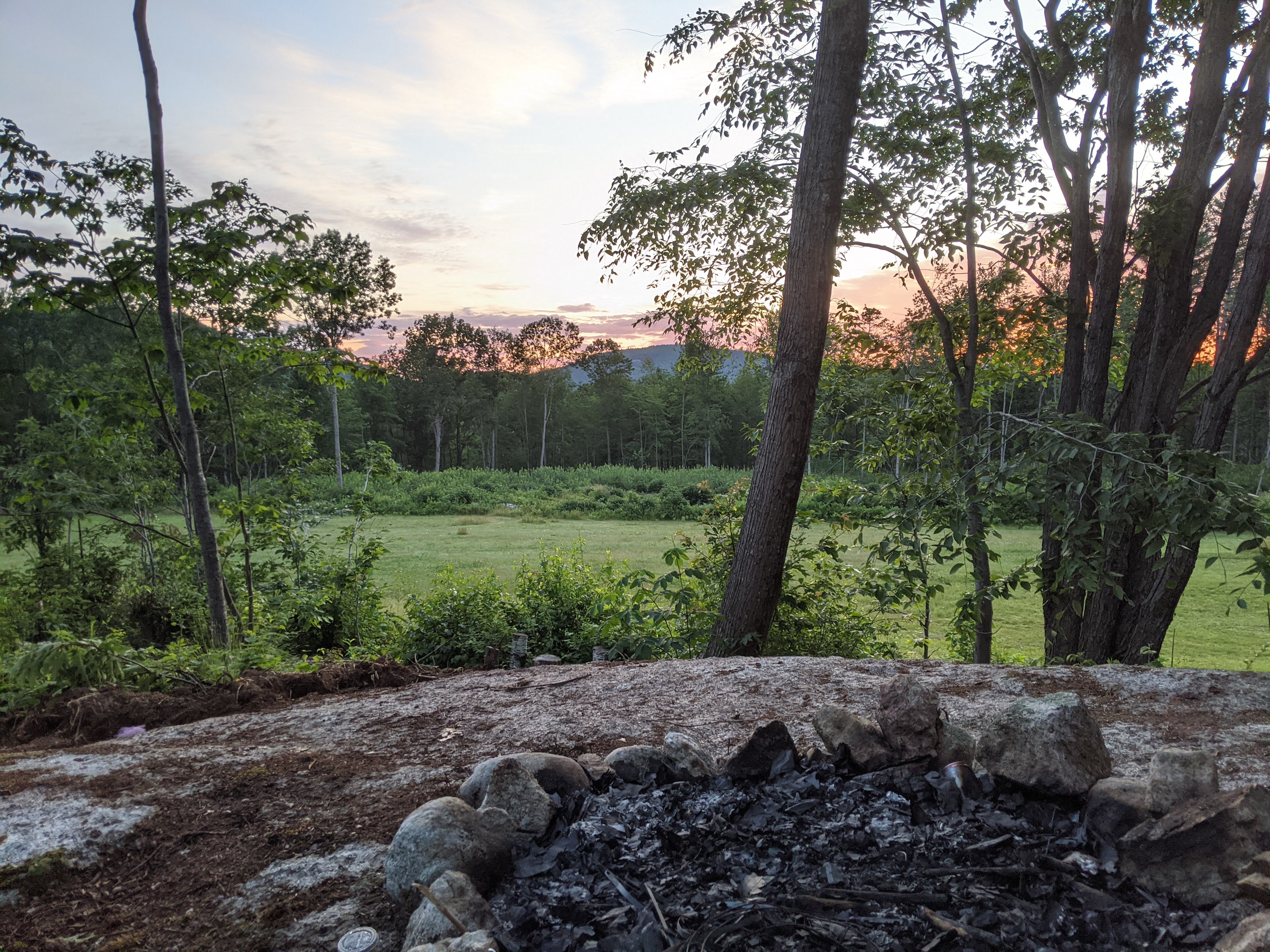 Fire pit (located in the bunch of trees in the field, on a giant rock)