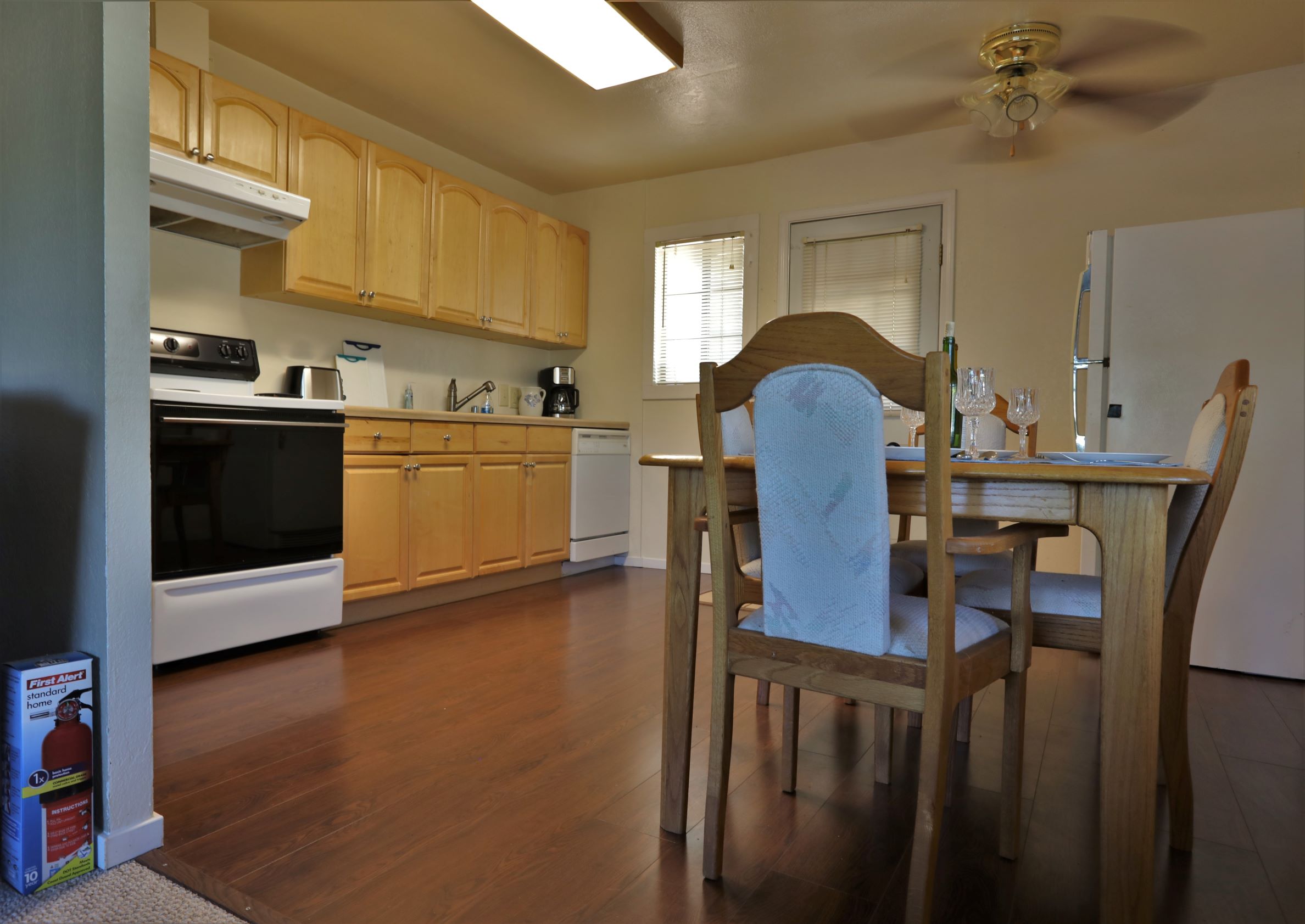 Kitchen and dining room showing refrigerator.