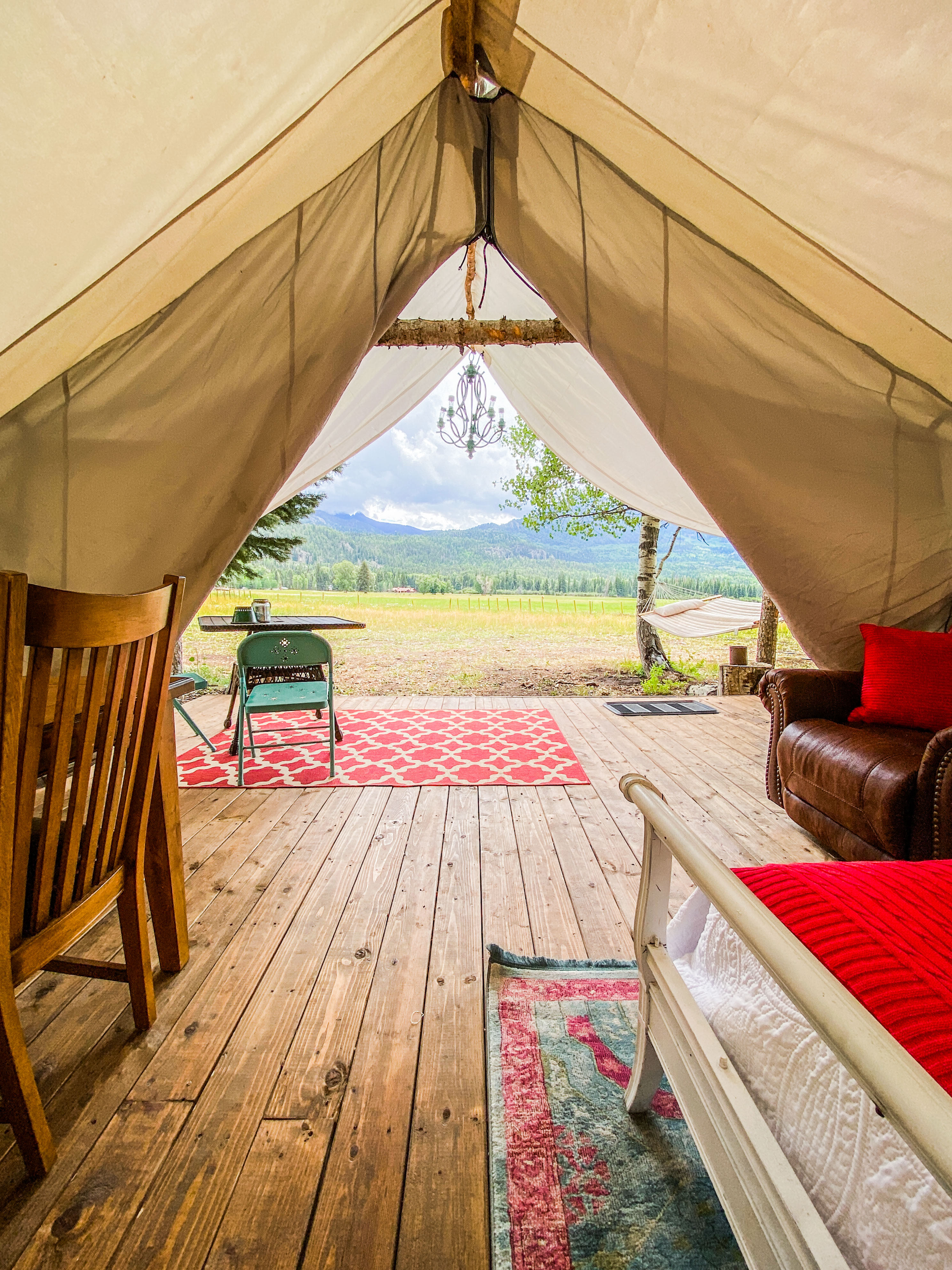 Caruso Tent [sleeps 6] outfitted with two queens and two twin beds featuring luxury linens, soft bath towels and battery-operated candles. Bring flashlights for additional lighting.