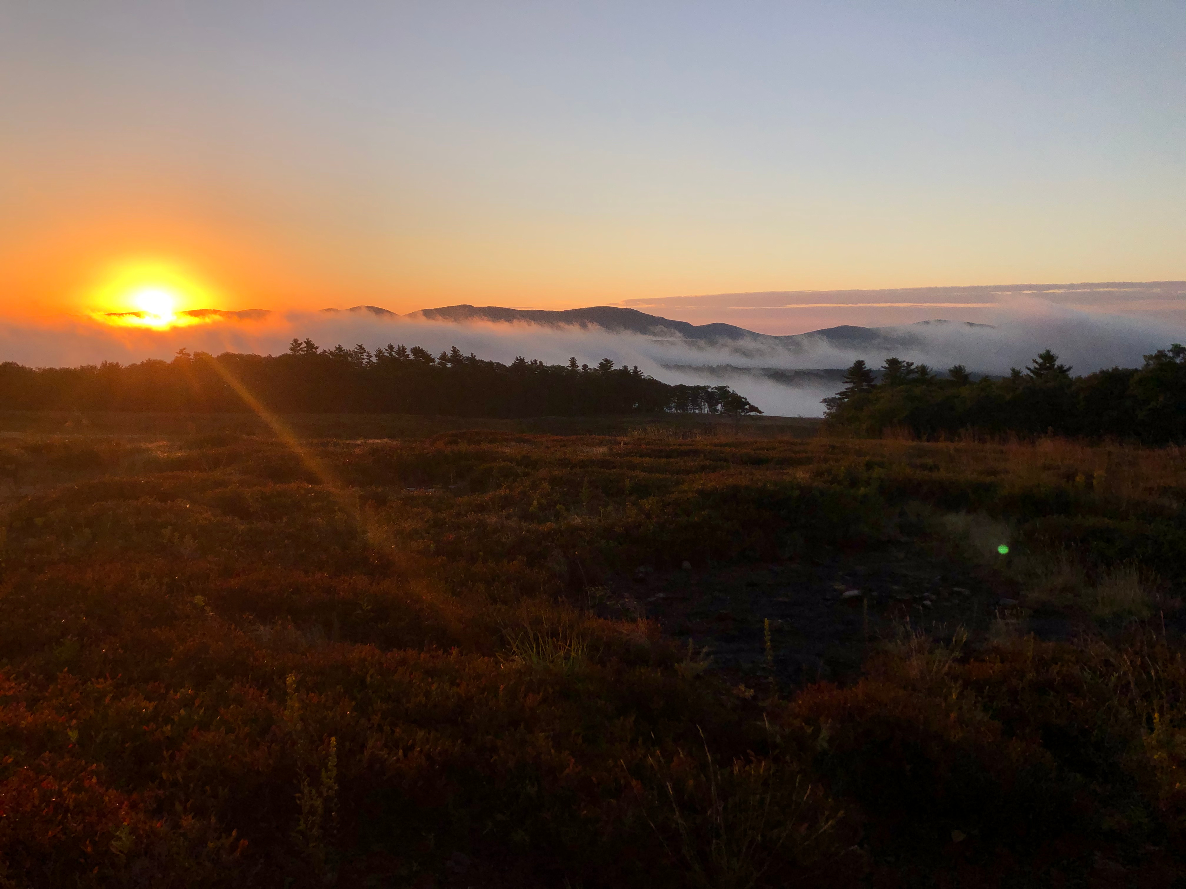 Clouds rolling through the hills at sunrise.