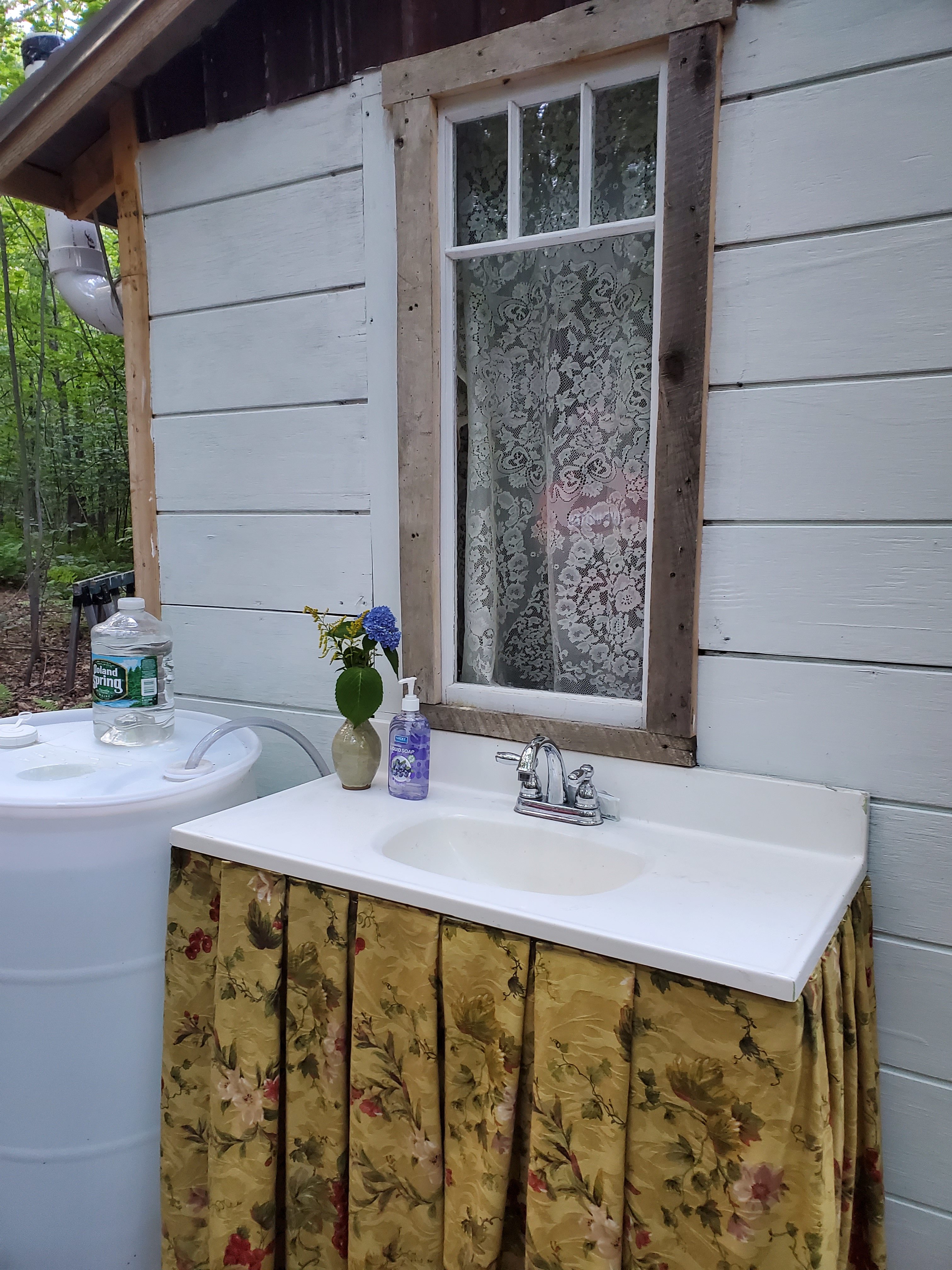 A foot pump under the sink skirt brings potable water to the faucet for easy cleanup and potable water is provided in jugs as well.