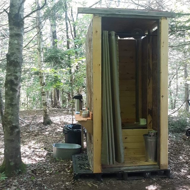 The composting outhouse is cleaned twice a day, and has a hot water hand washing station, sanitizing spray, and is also the location of an outlet to charge any devices you may need. Tools and other neccesities are located next to it for use during your stay.