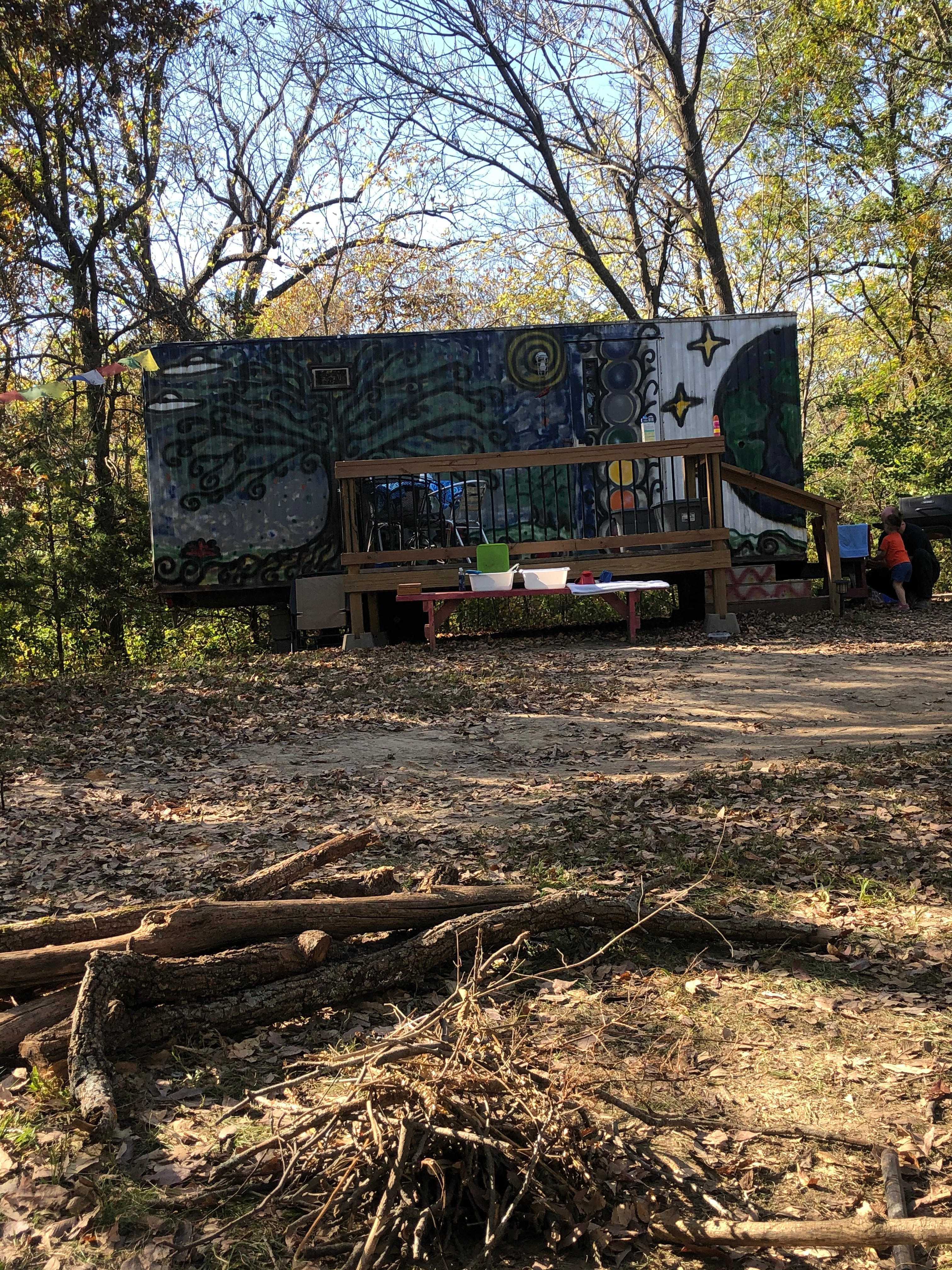 Front view of Hippie Trailer and deck from the fire pit area