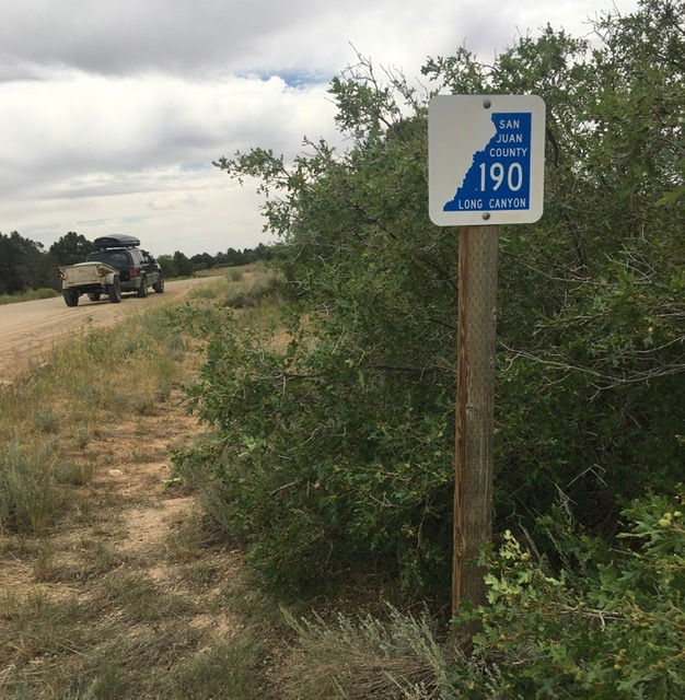 Sign after you leave the highway on the right against the shrub oaks