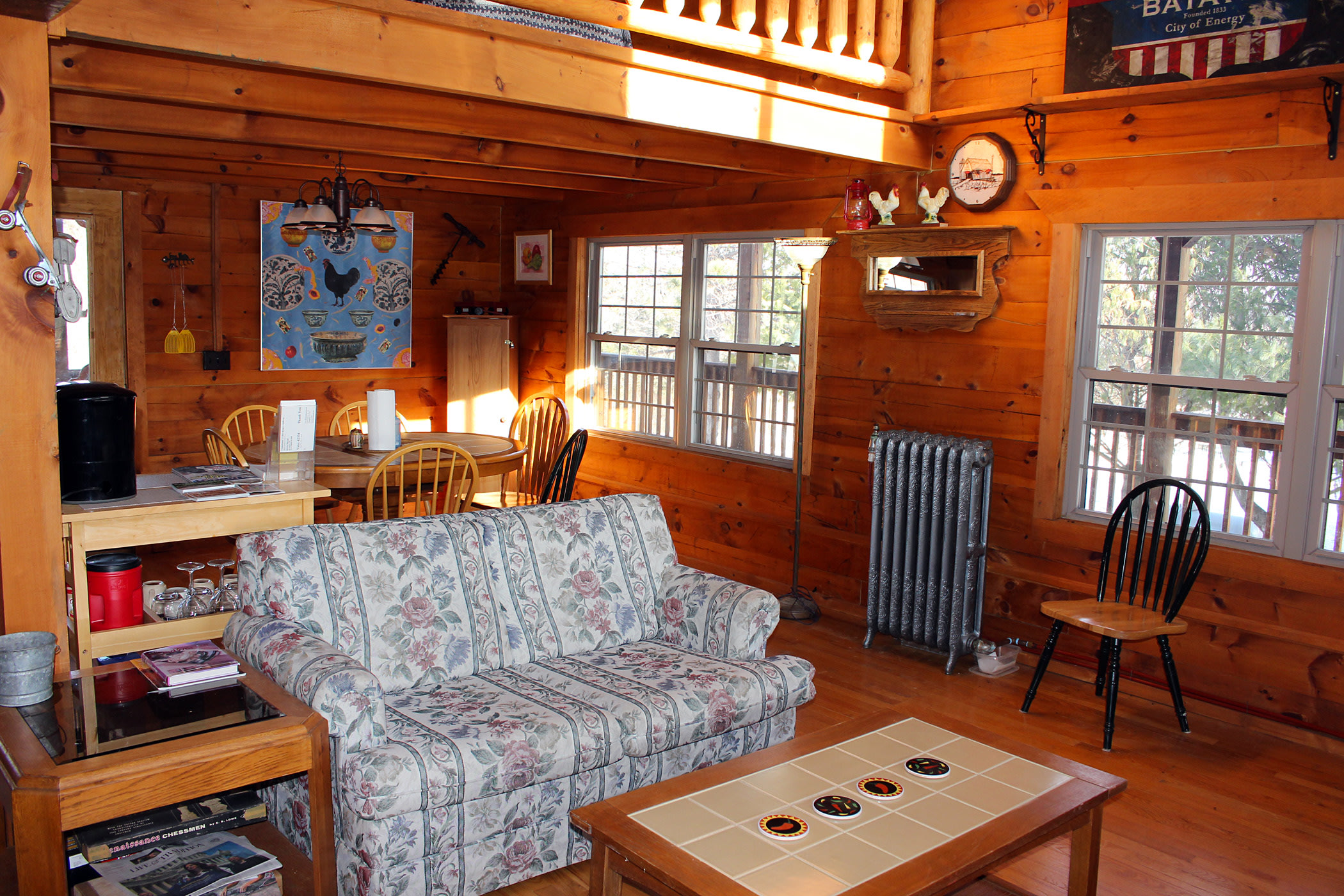 Large open living room/kitchen design with cathedral ceiling. Lots of windows and natural light. 