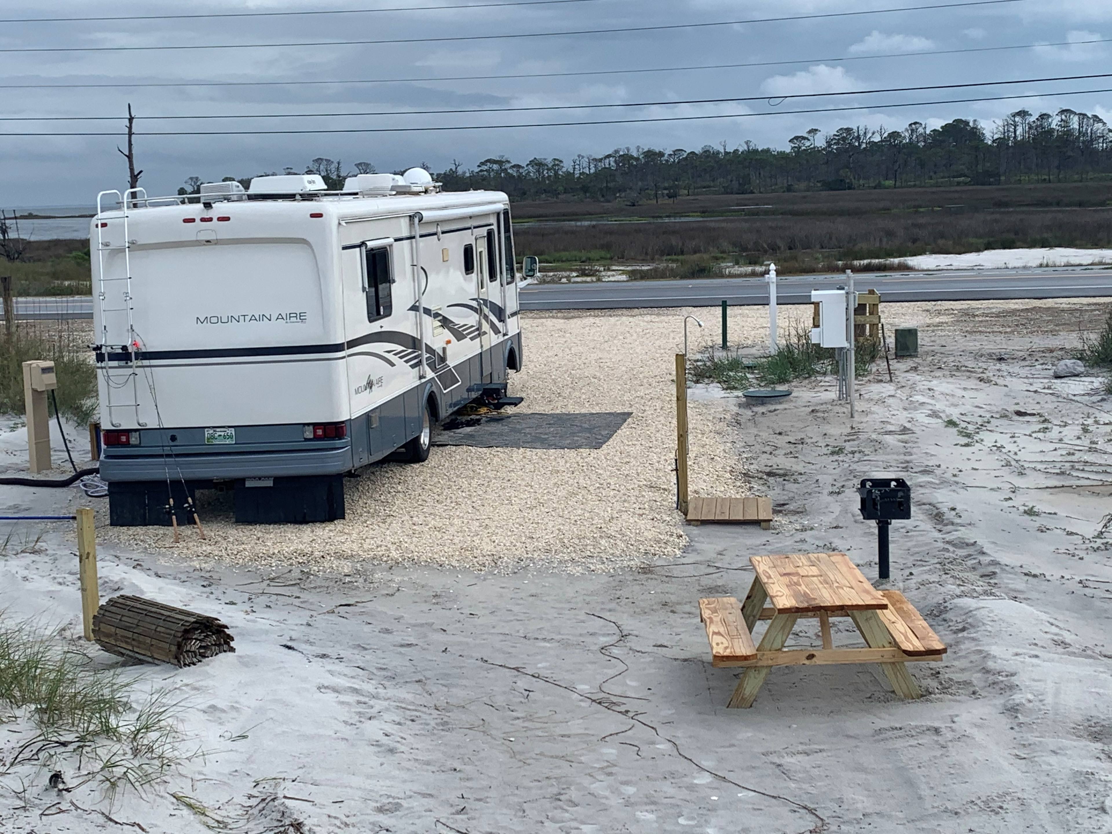 picnic table, grill, and outdoor shower