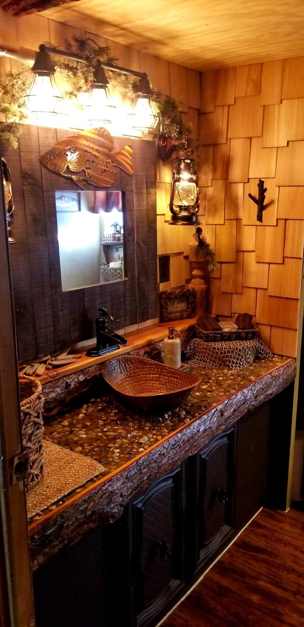 Our river rock countertops in the bathroom give the feel of a fishing stream!
Lantern light fixtures & cedar shakes on the walls, give the warm feeling of a cabin!