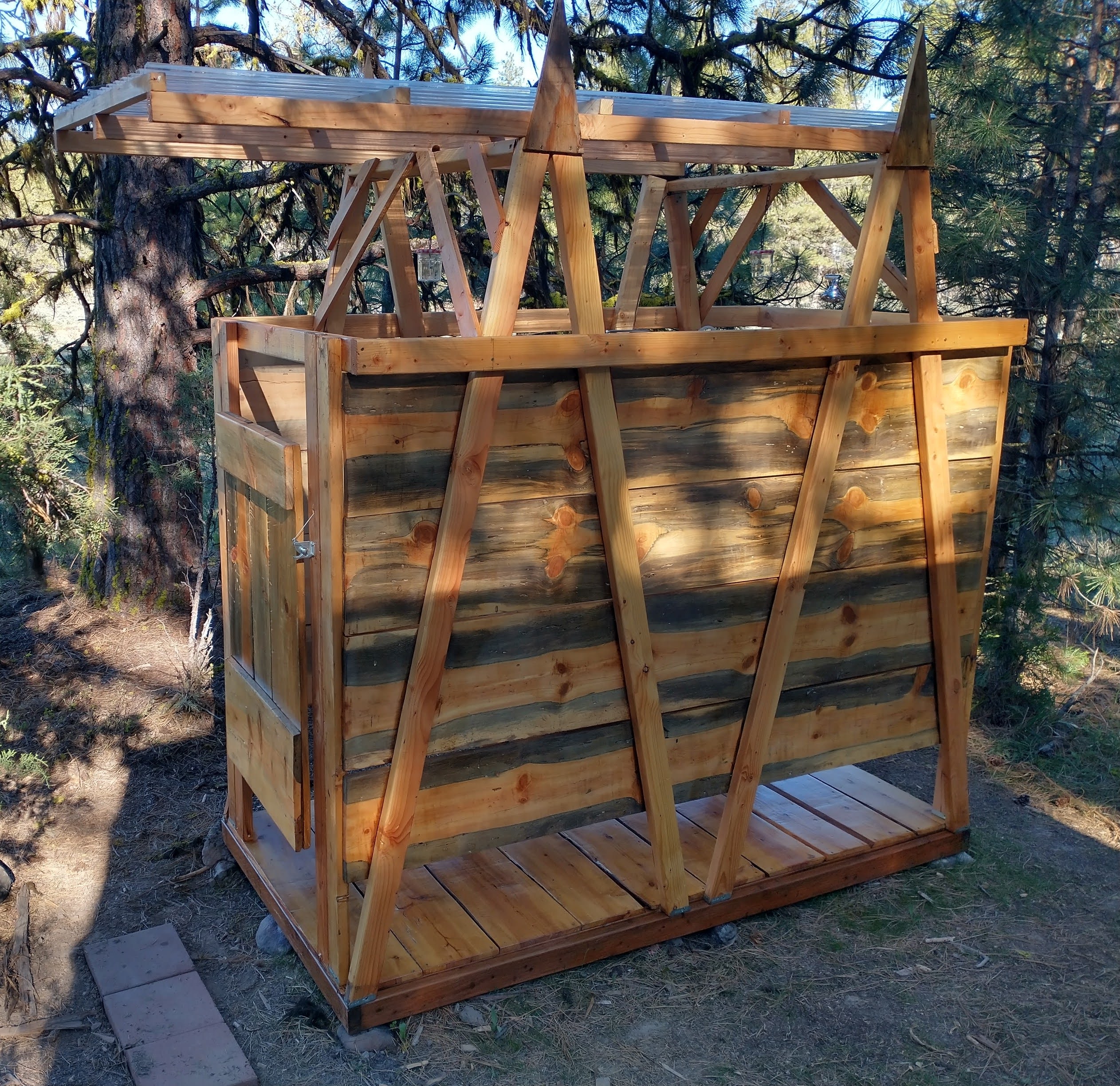 Outdoor shower and composting toilet.  Built from blue pine and cedar harvested and milled here.
