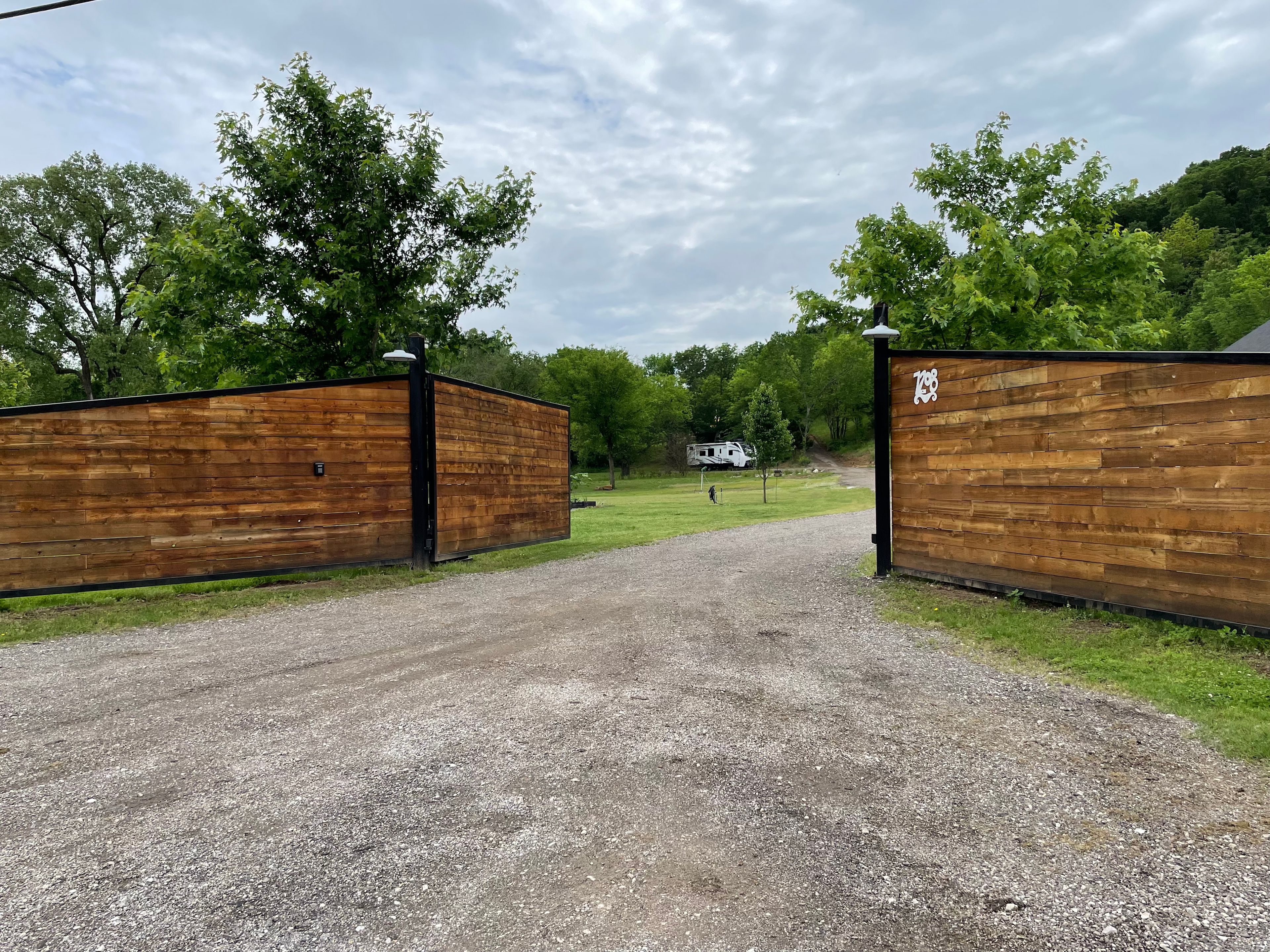 Southern facing view of gate and driveway. 

(Our personal RV pictured, so you can see how an RV looks in the space.)