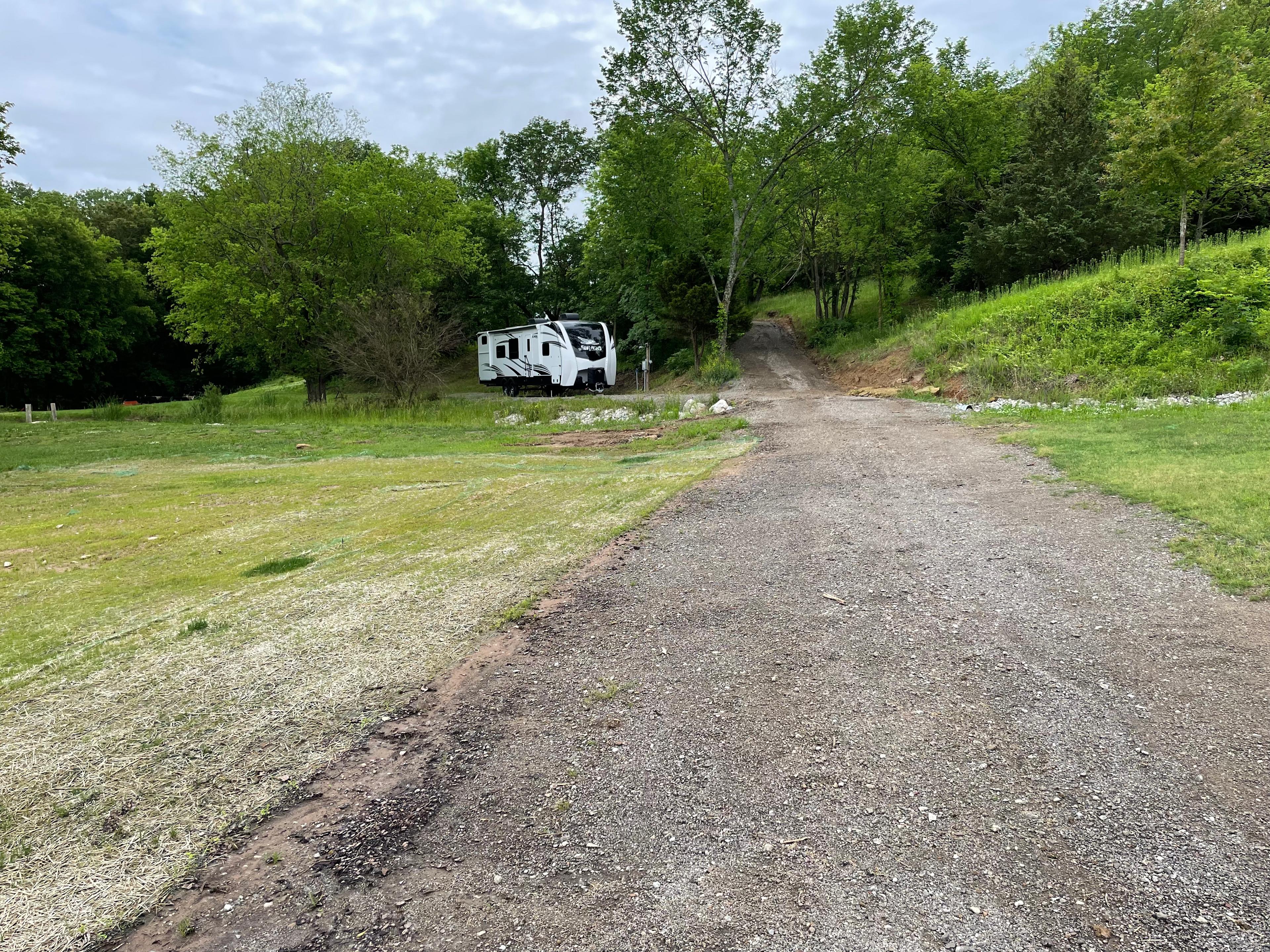 Southern facing driveway view of RV site.

(Our personal RV pictured, so you can see how an RV looks in the space.)