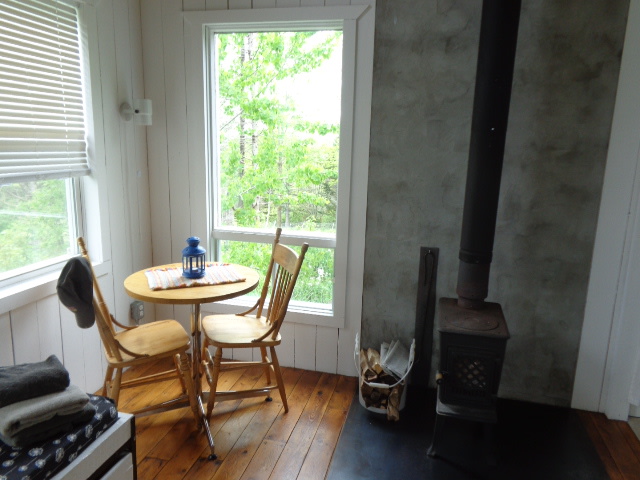 Cozy eating nook with wood stove.