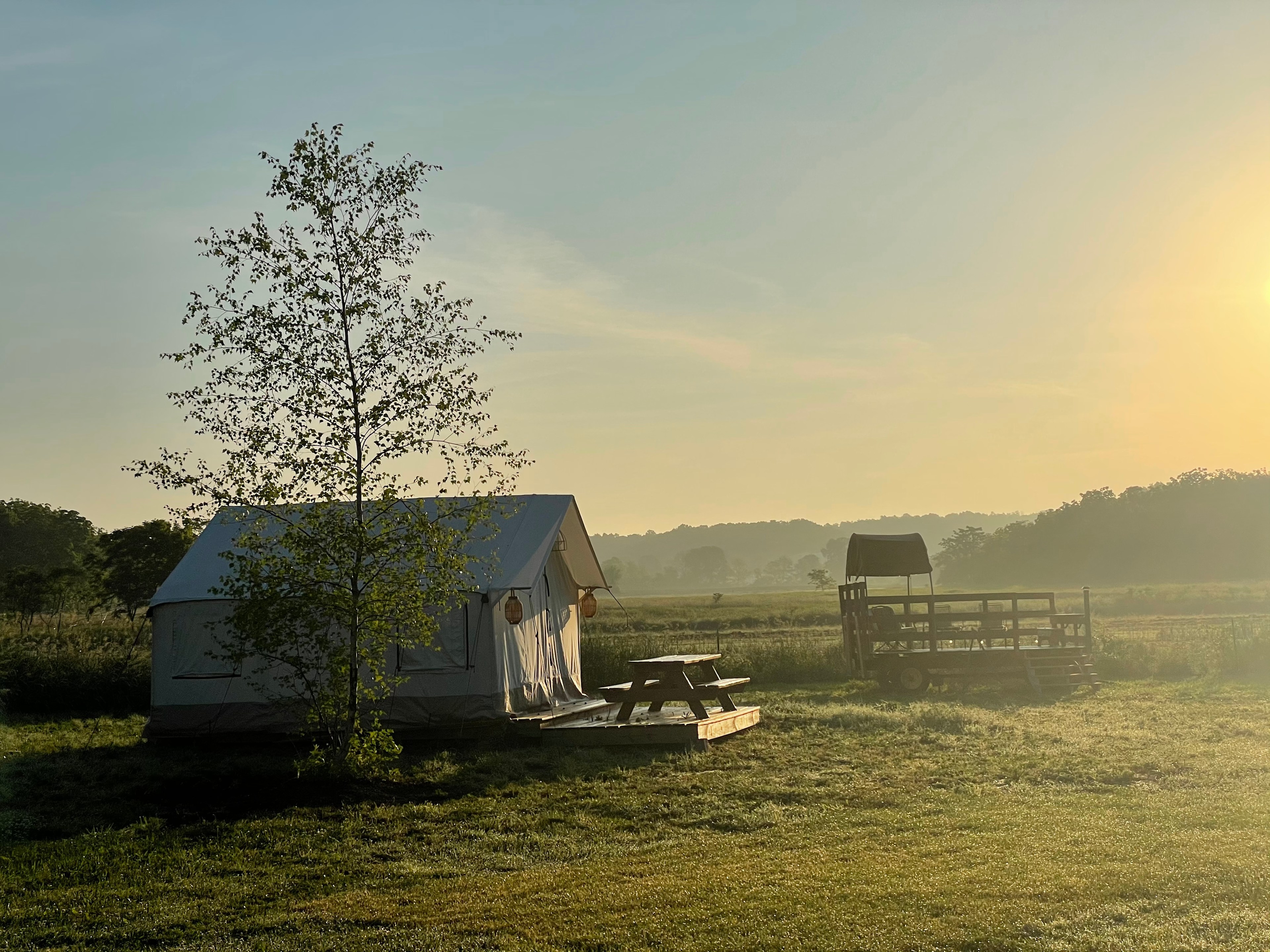 Spectacular sunrise side view of Safari Tent #2 and the communal wagon