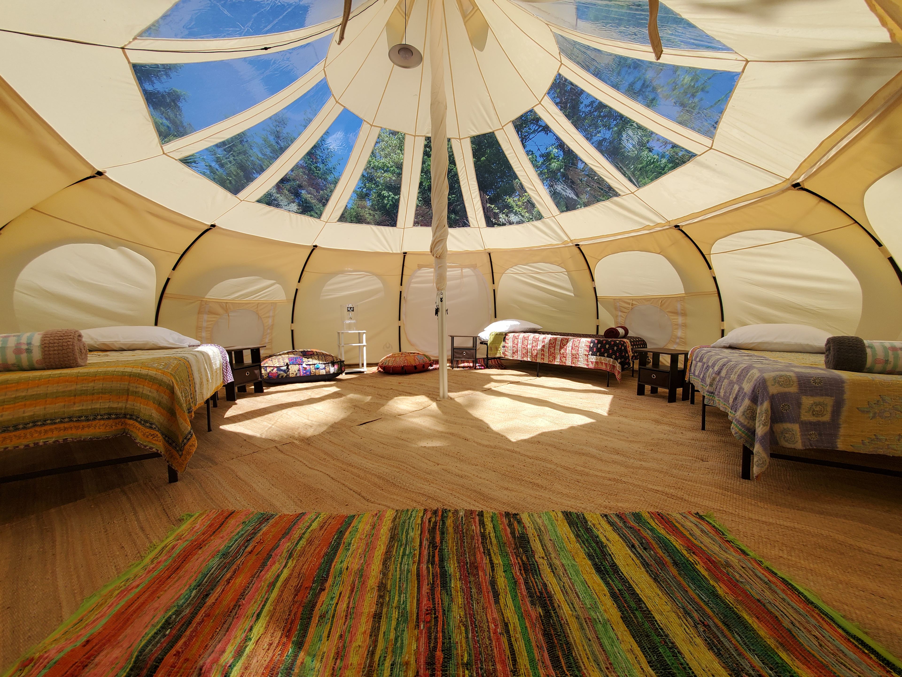 Site #1, our 20-foot Lotus Belle Stargazer tent is perfect for a peaceful night under the stars for two, but also big enough for up to 6 beds comfortably. All our tents include beds, memory foam mattresses, and an extra blanket in case you get cold.