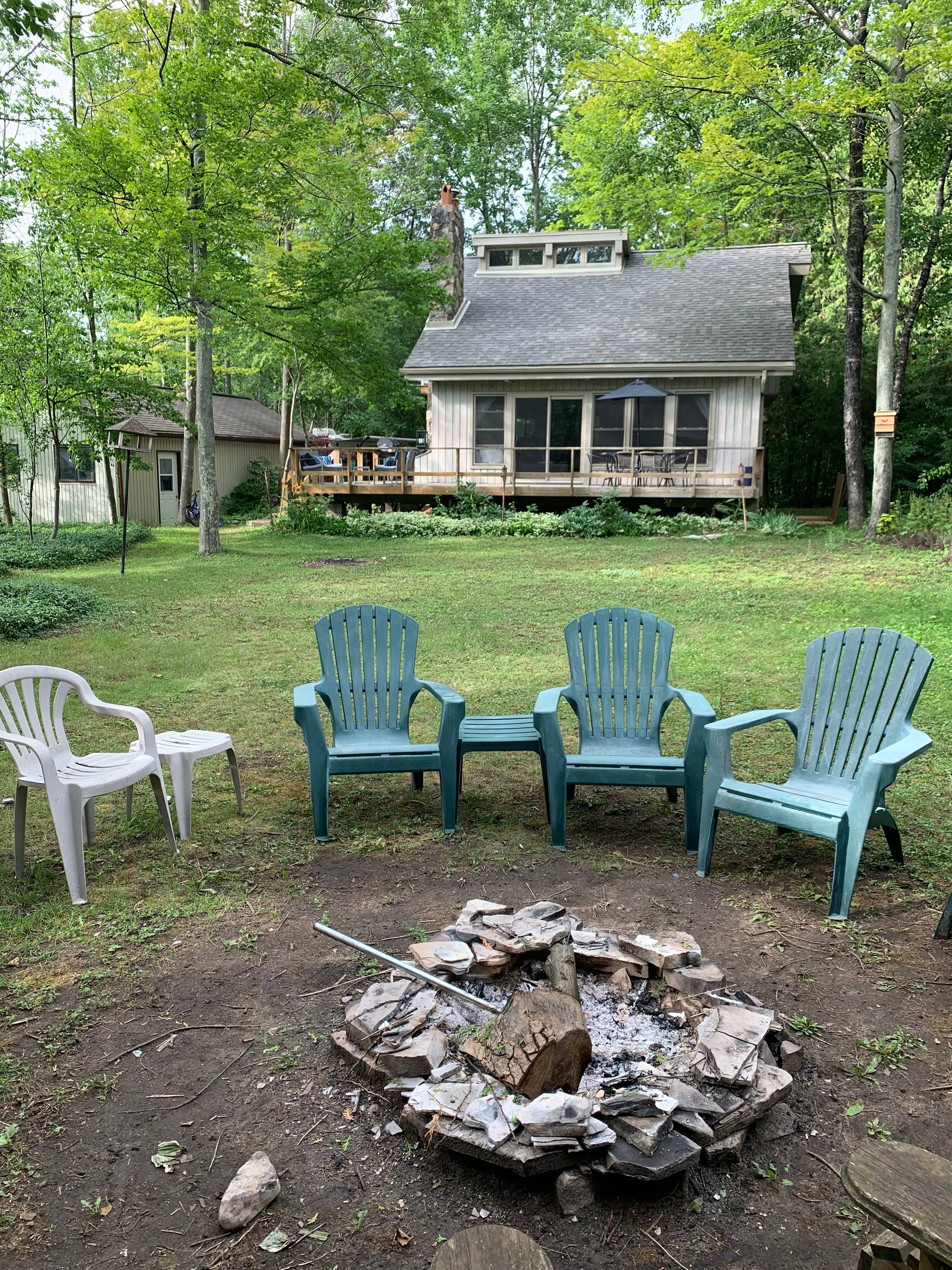 Fire pit at the back of the property for you to enjoy. Kindling, firewood, and marshmallow roasting sticks provided