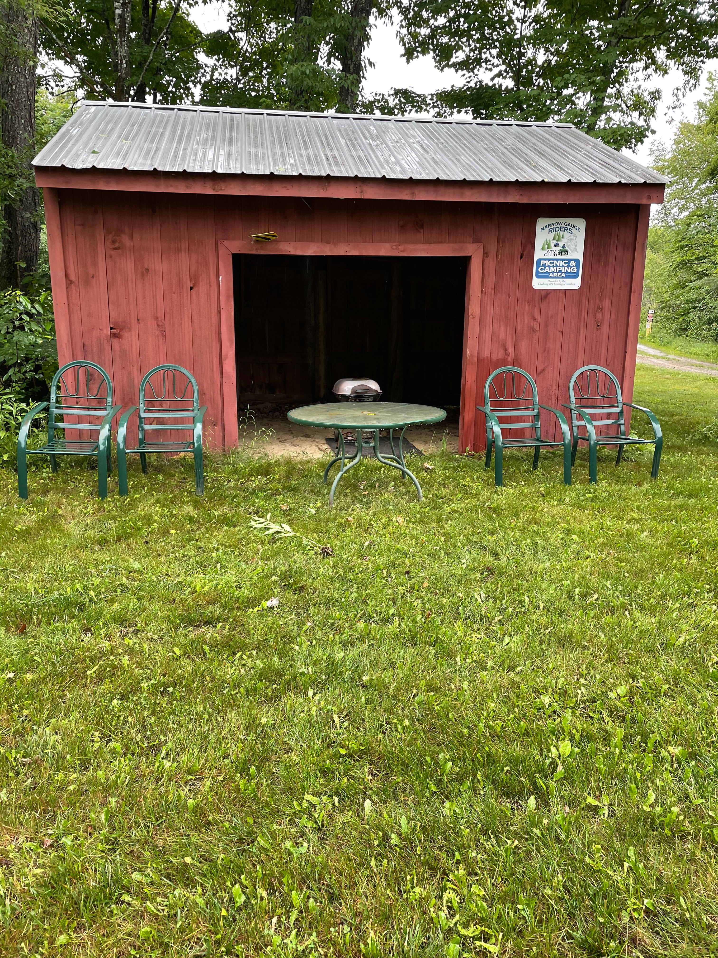 Table and chairs and a small charcoal grill on site.