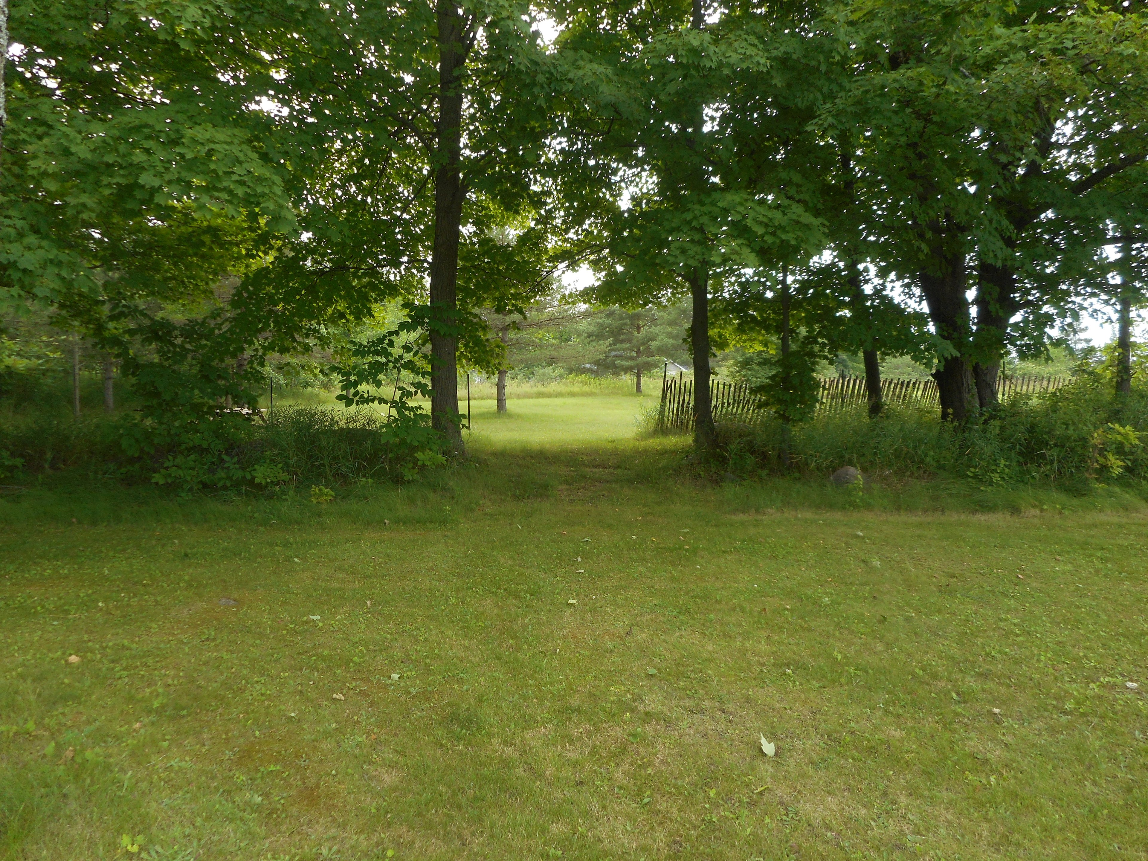 Ideal spot accessible off the main driveway then through the opening that will accommodate smaller trailer and or tent 
