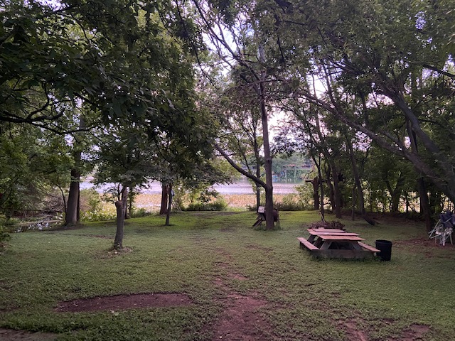 Community water area with grill ,fire pit,boat ramp and  table.
