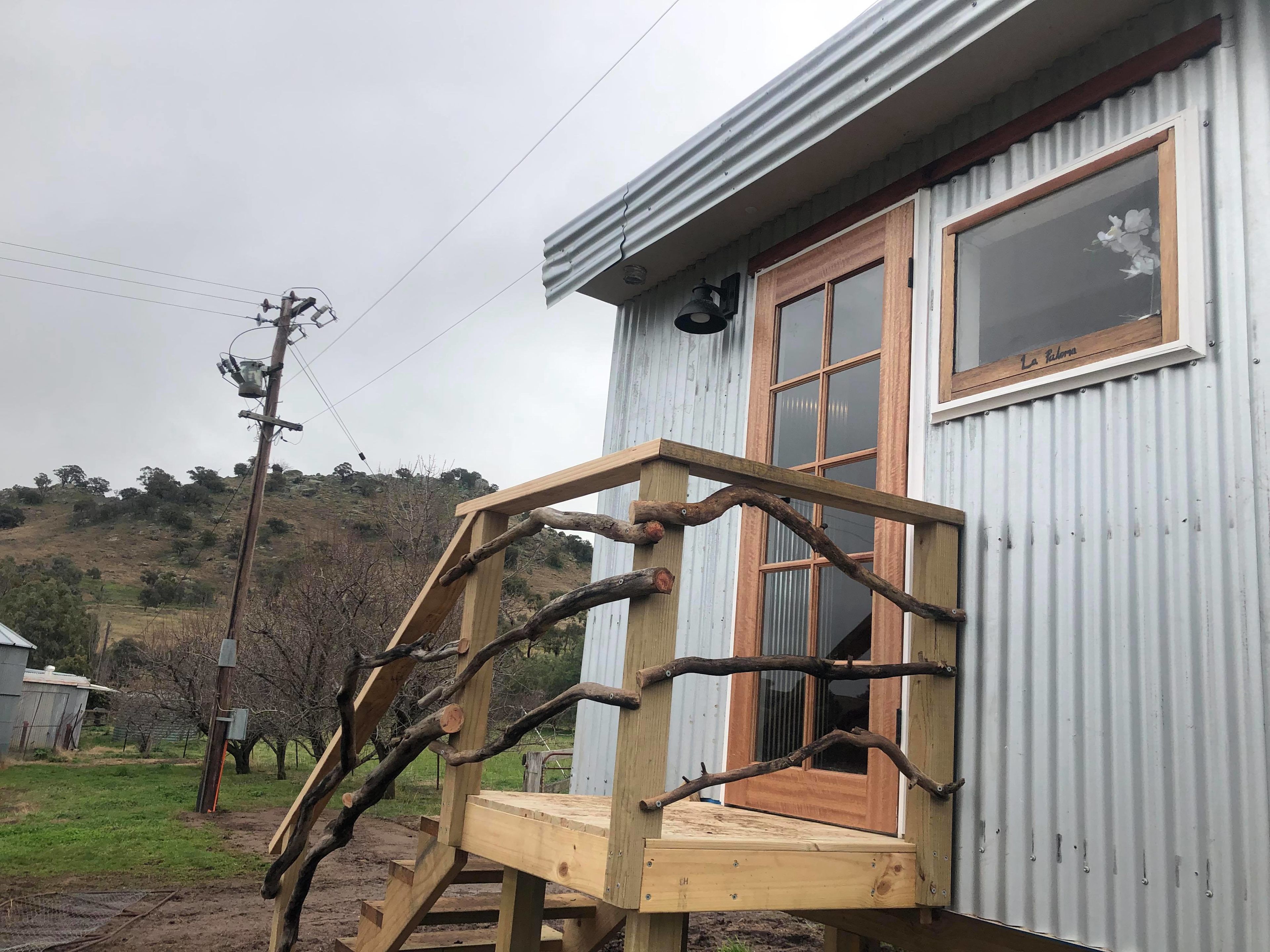 Bathroom block with 2 toilets, shower and sink. Camping area in background (near the power pole).