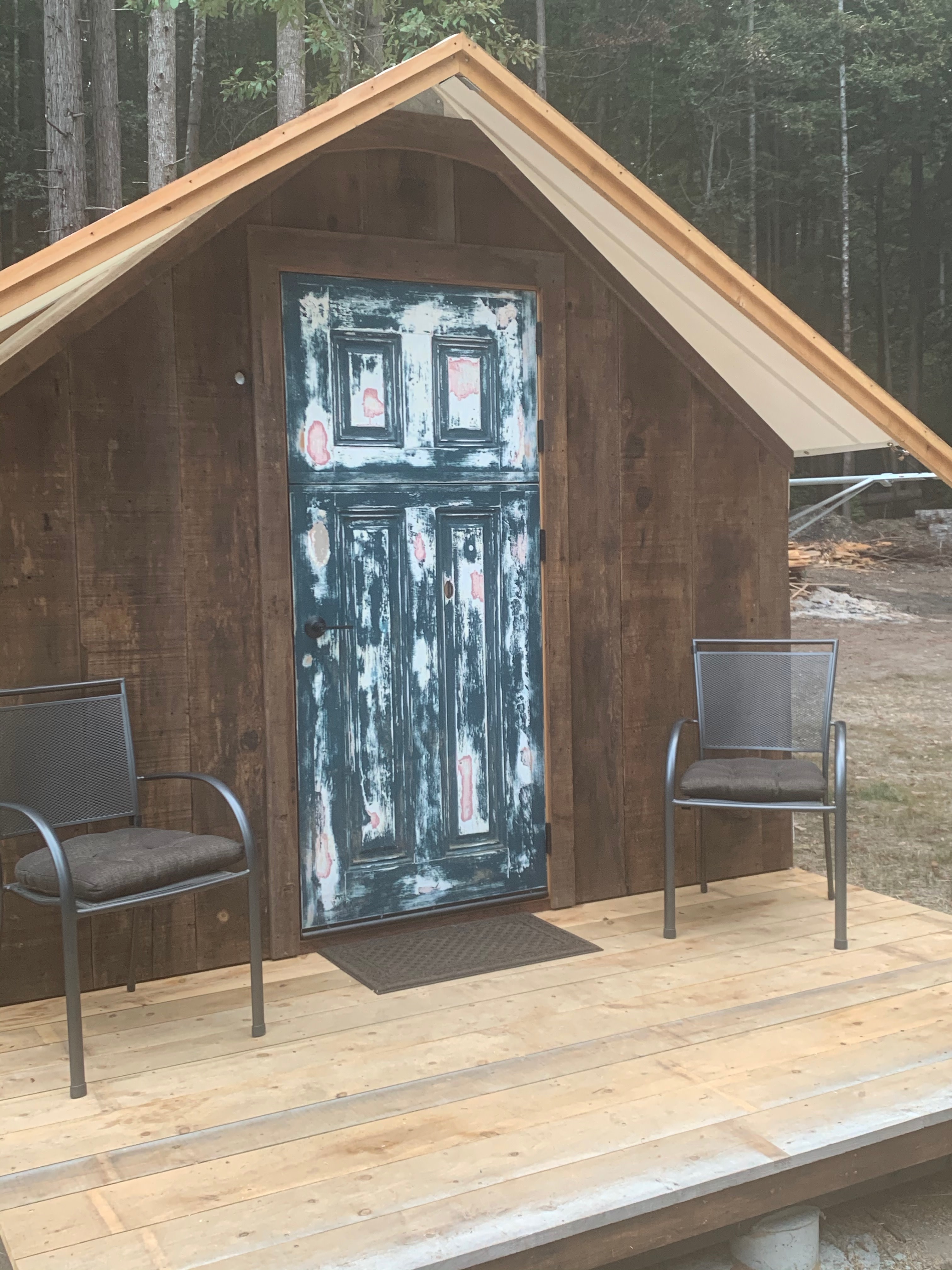 Cabin 2 has a Dutch door and recycled redwood paneling on one exterior wall. 