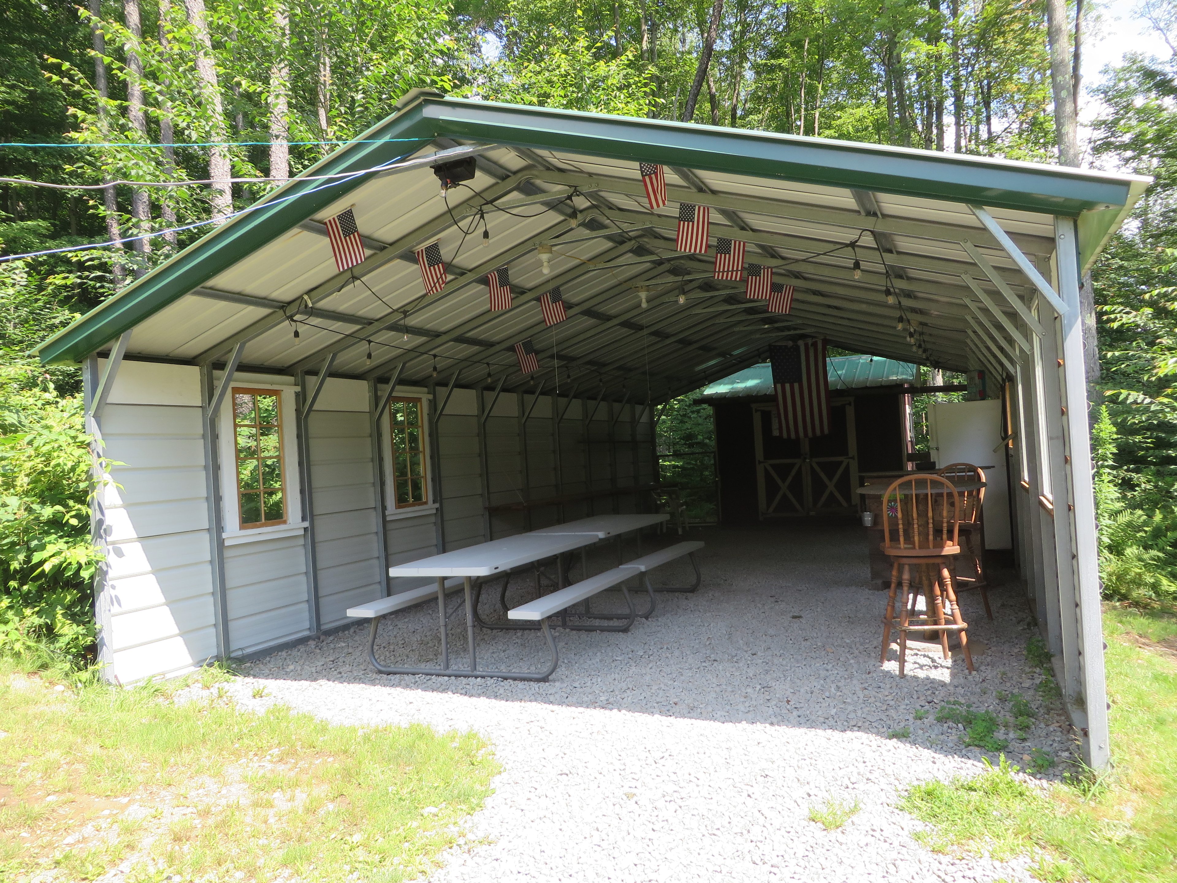 Let's gather in the pavilion! Pavilion has task and ambient Edison lights, picnic tables, dry shelving, small counter/bar area with stools, full size refrigerator/freezer, small appliance station with bulk 15 cup coffee maker and first aid kit.                                                                                                
