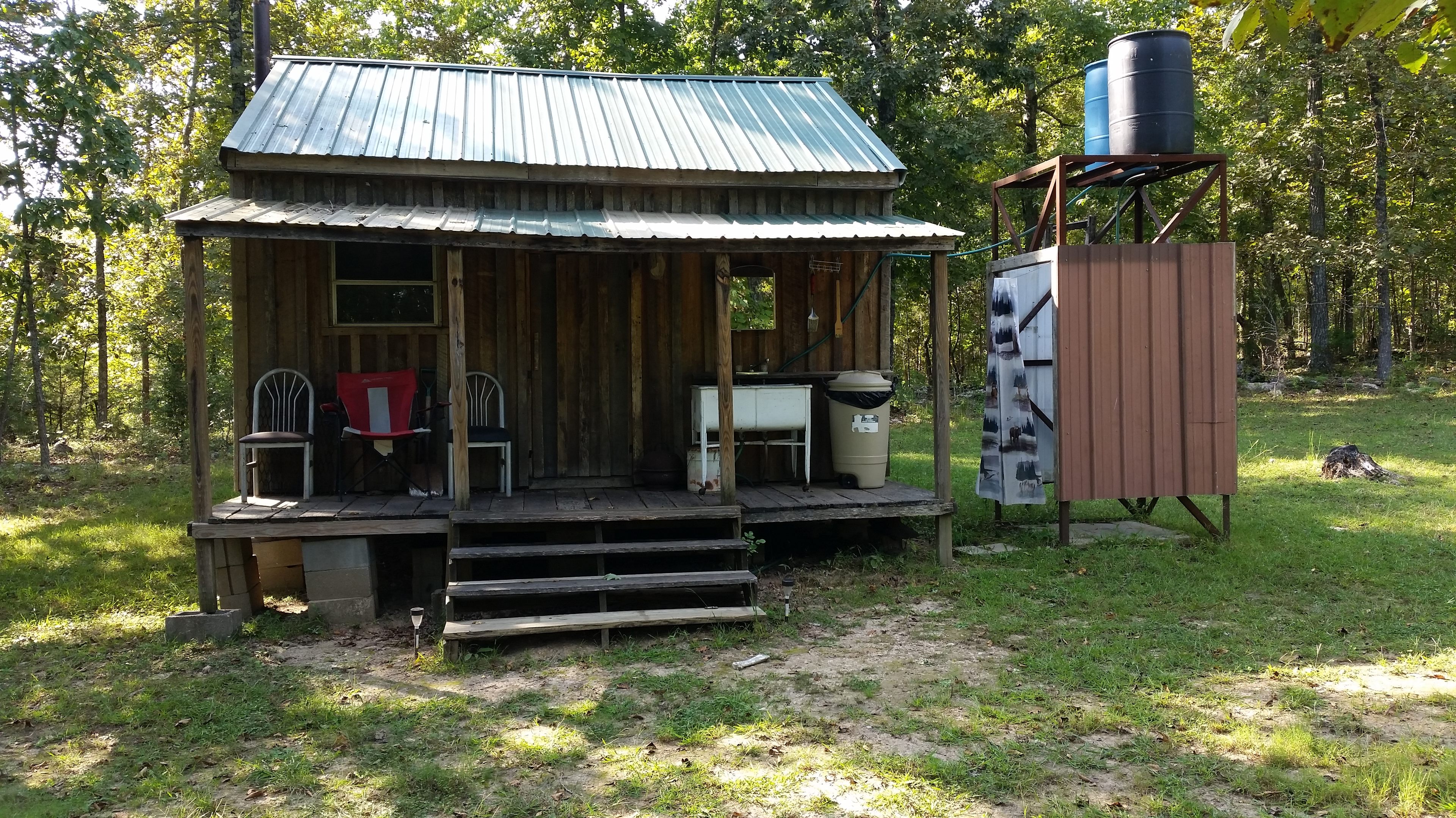 Back porch with gravity-fed sink and outdoor shower 
