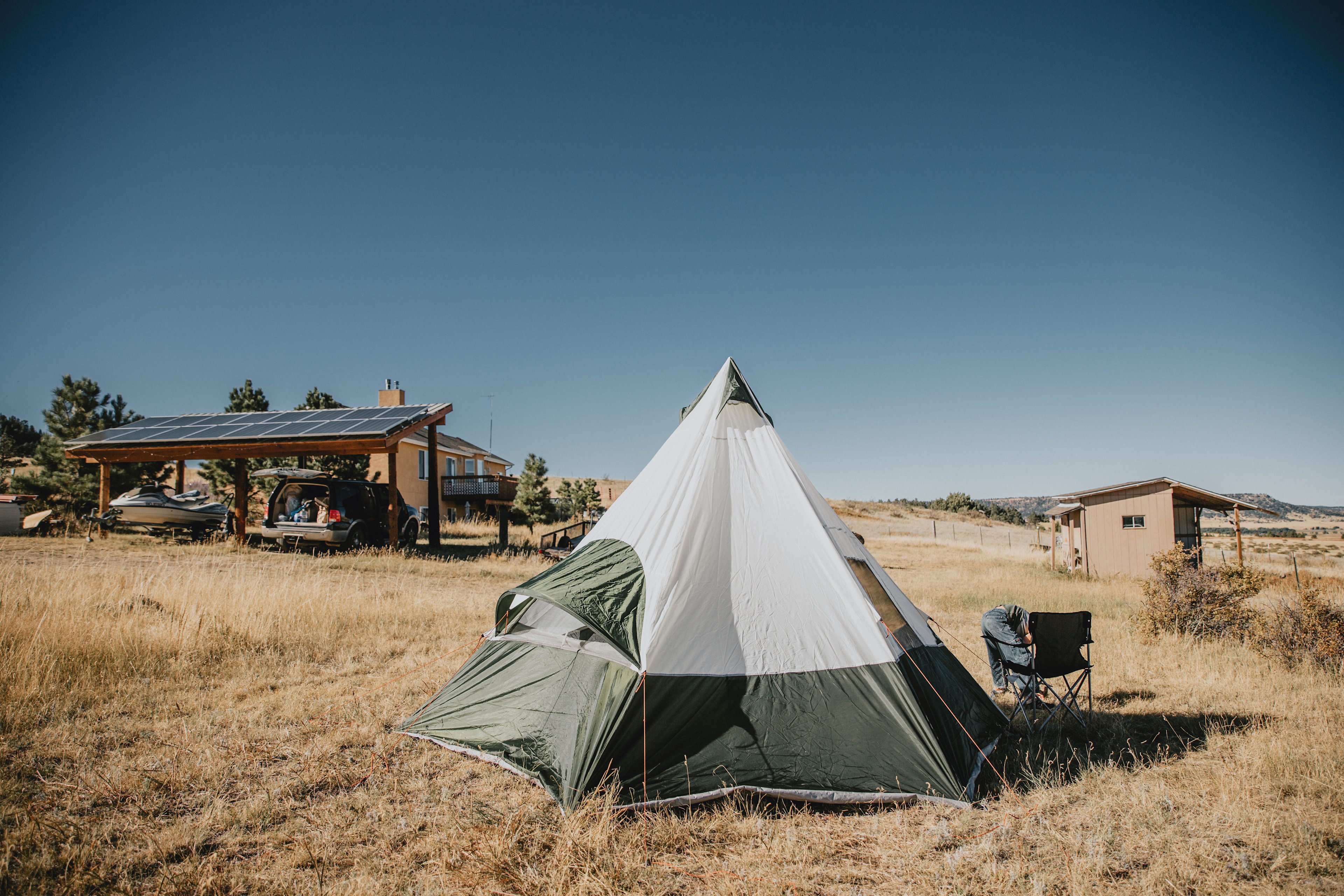 View from the corner of the property. You can see the parking area, hosts house behind it and outhouse shed on the right.