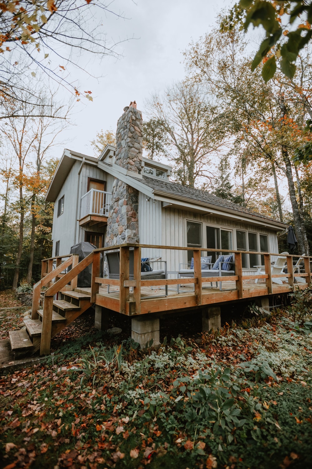 The back of the cottage features a large deck with plenty of seating and a barbeque