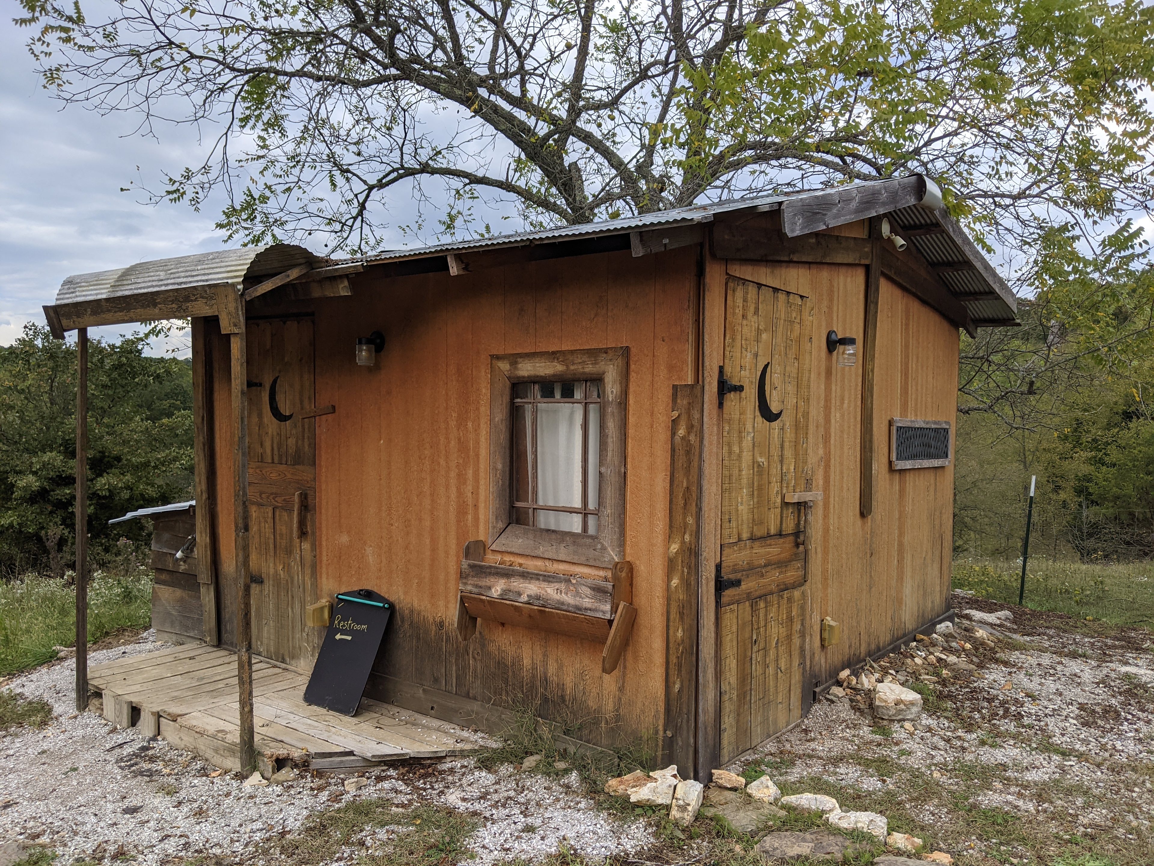 The restroom building you will use with a flush toilet and sink.
