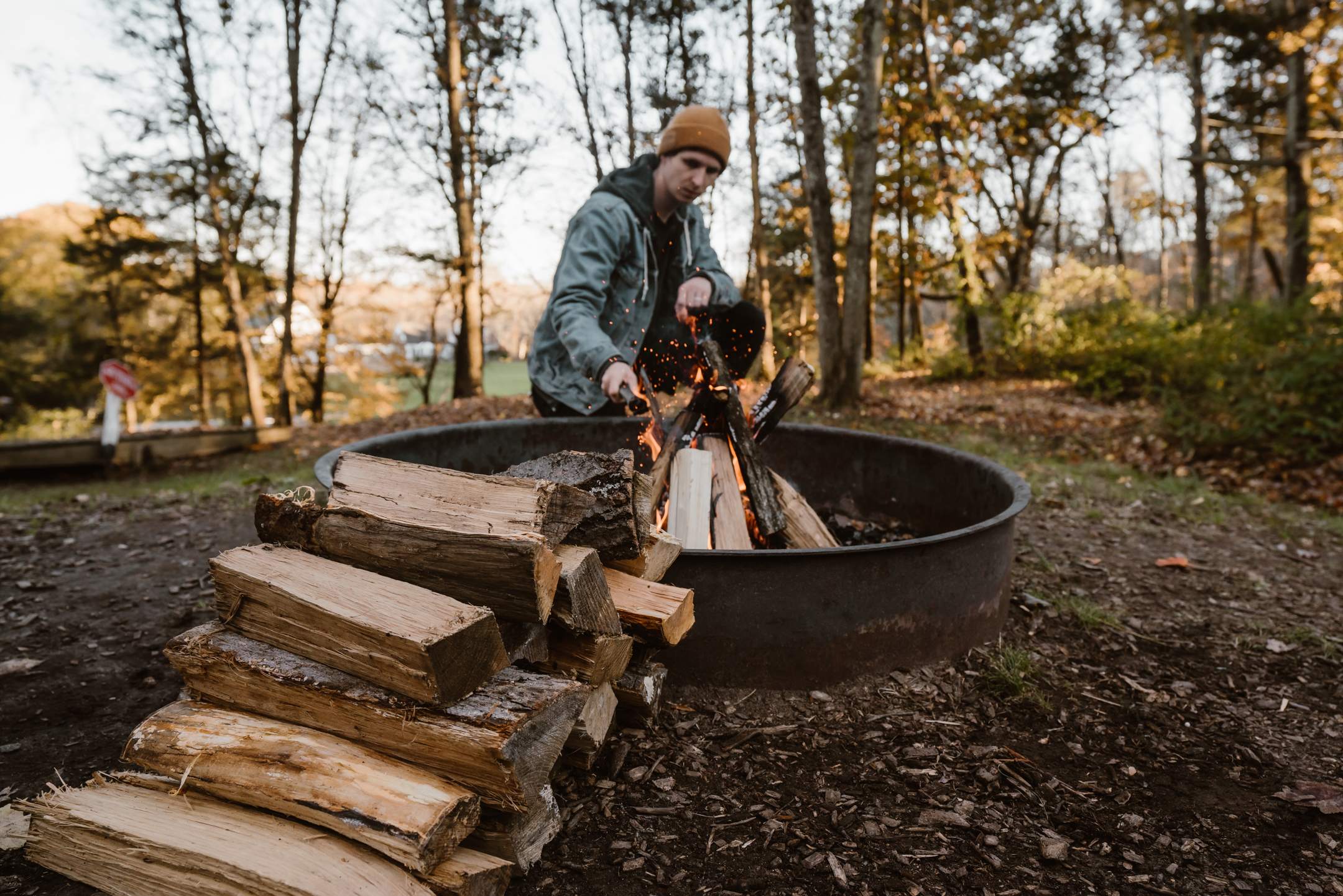 Starting a camp fire in the fire ring.