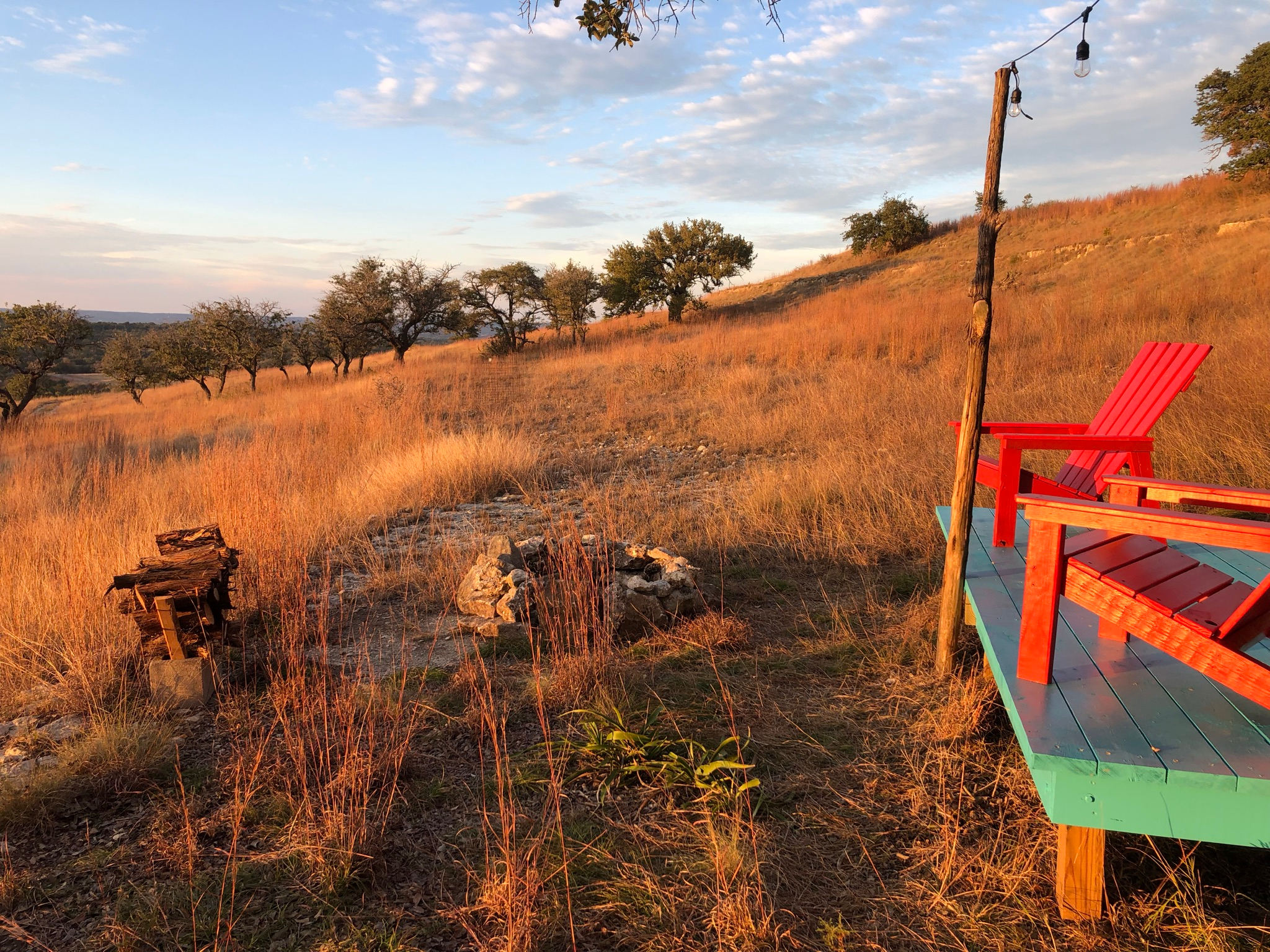 Catch a sunset from the two Adirondack chairs on the deck of the tent over looking the fire ring and valley beyond