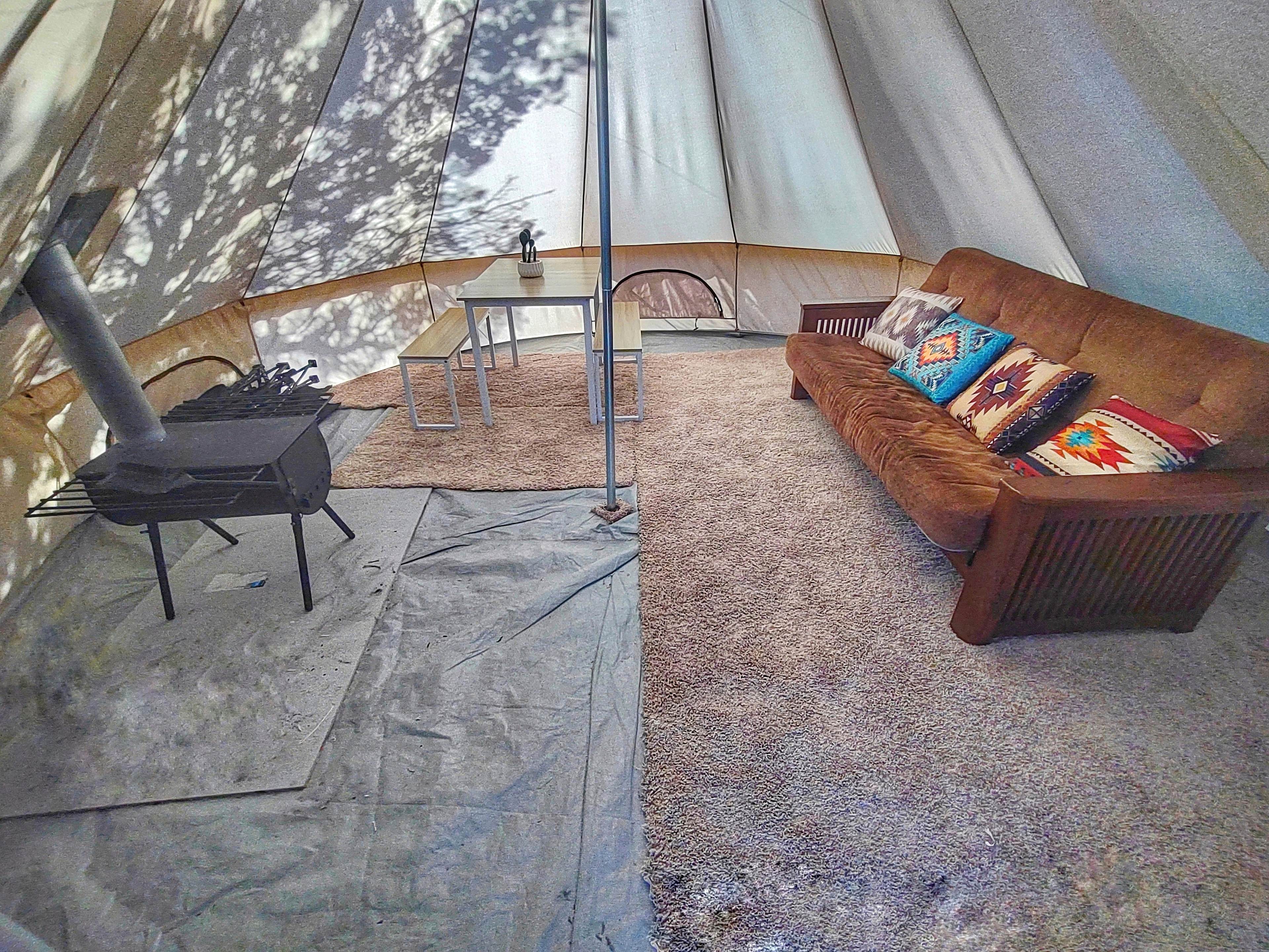 Interior of tent with wood stove.