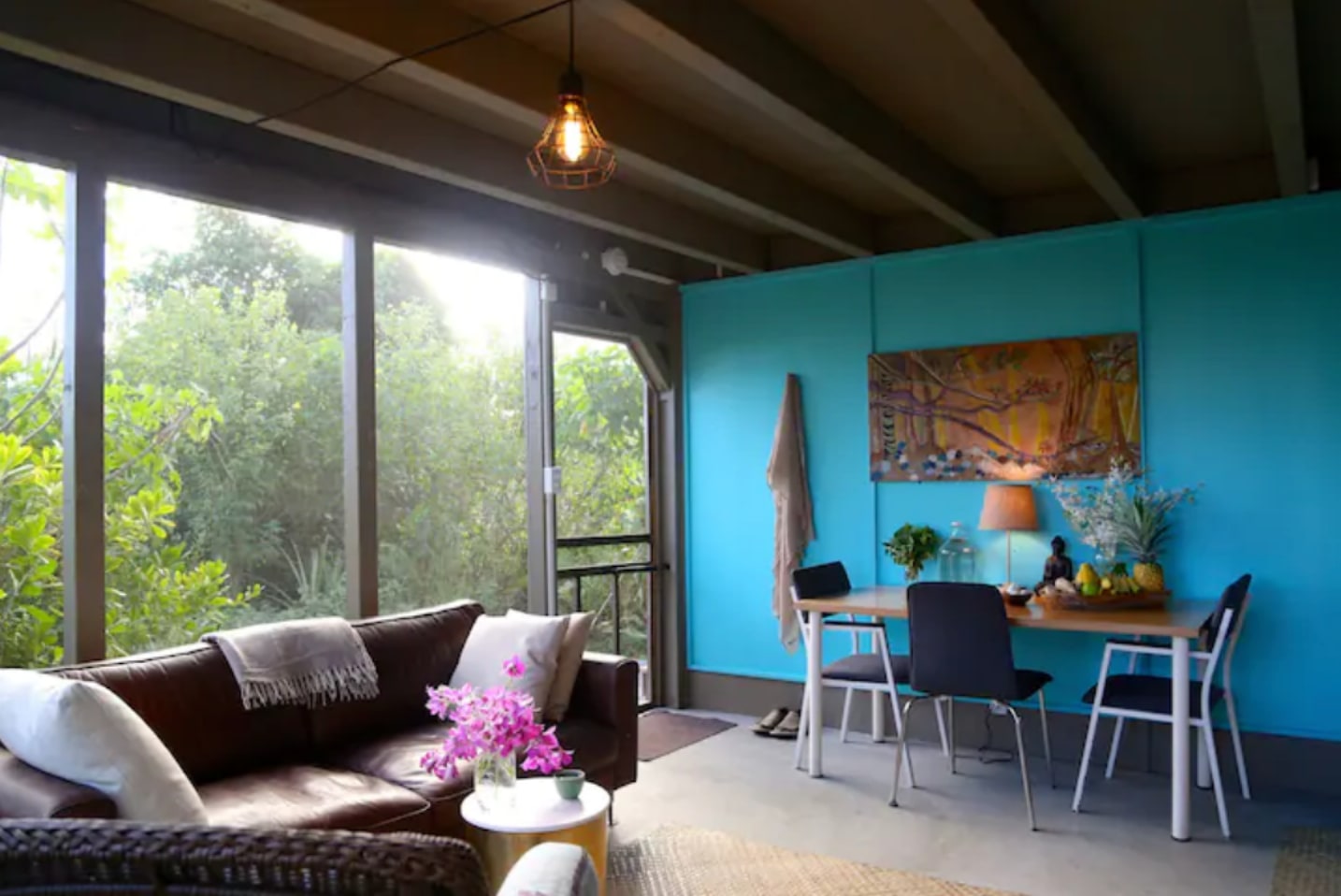 Lower area has a couch, dining area + summer kitchen with a sink, toaster oven, minifridge + hotplate.

