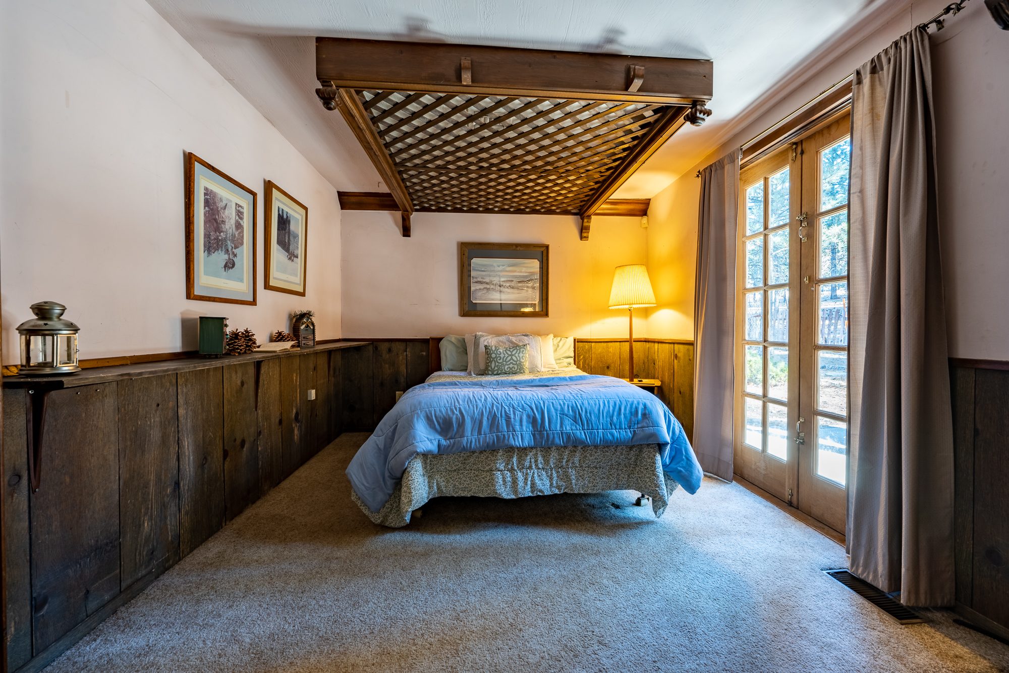 Large bed in the big bedroom, with a great view of the woods. 