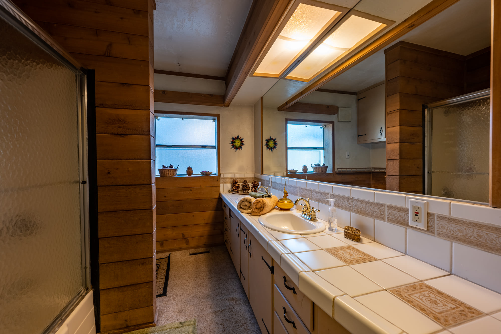 Bathroom in the big bedroom with tub/shower and flush toilet. 