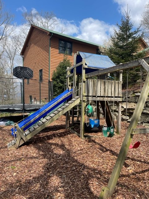 Playground with netted trampoline