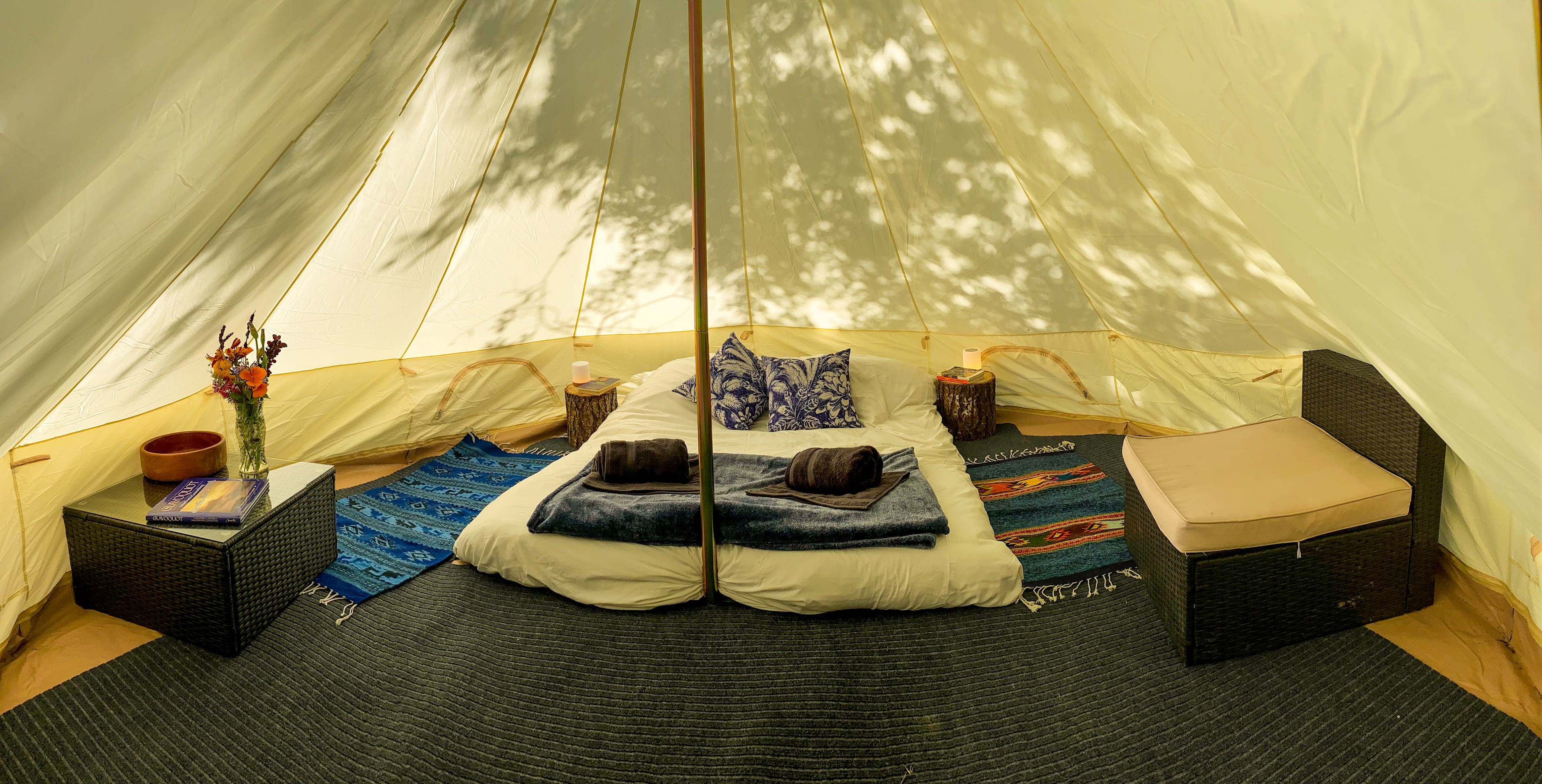 Inside is a queen size latex memory foam mattress, couch, coffee table, and solar powered lights. 