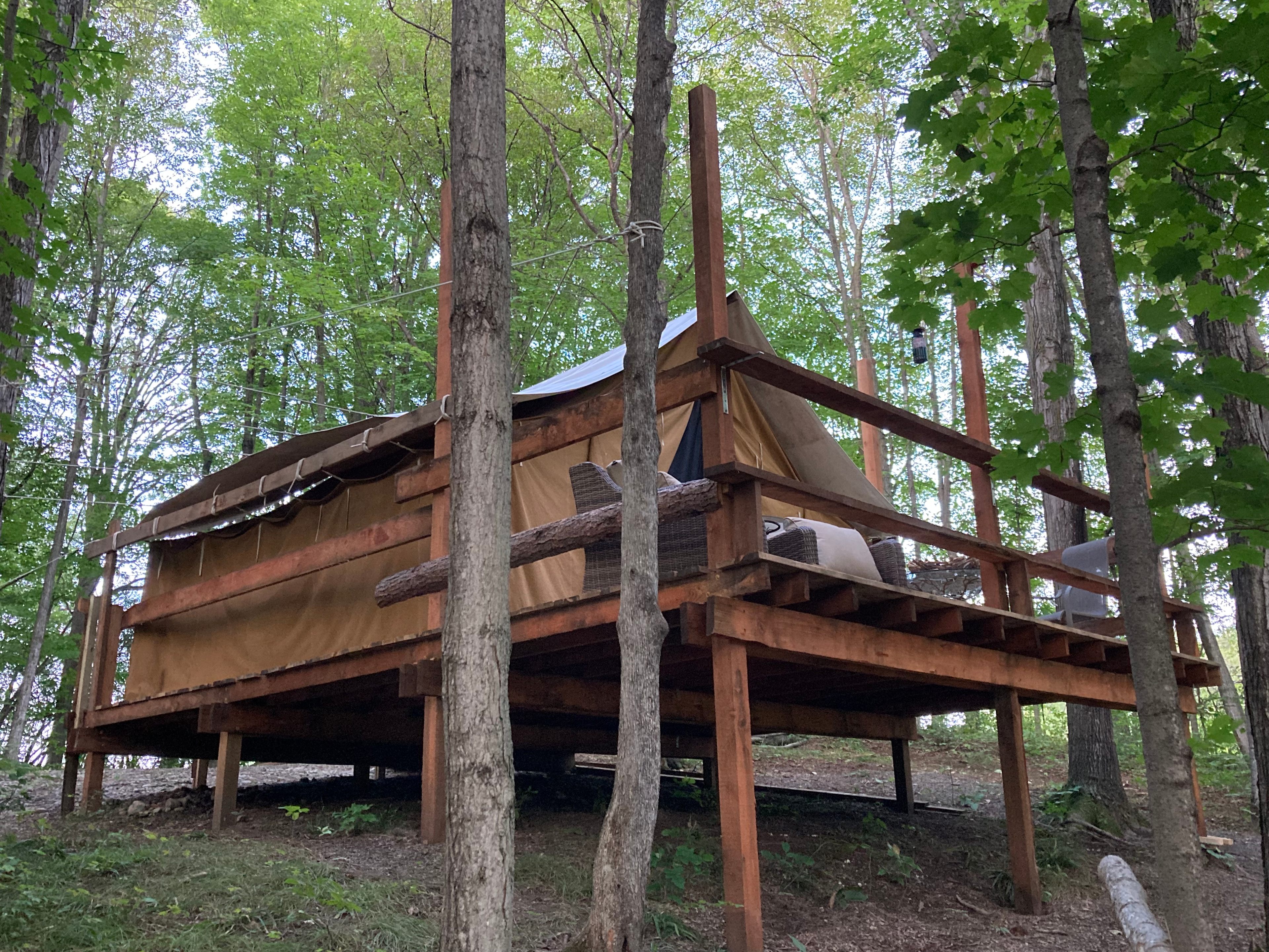 The Selah Serenity platform tent is nestled in a quiet spot in the woods. 