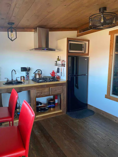 Fridge, microwave, stovetop, electric pizza oven and oil and spices...