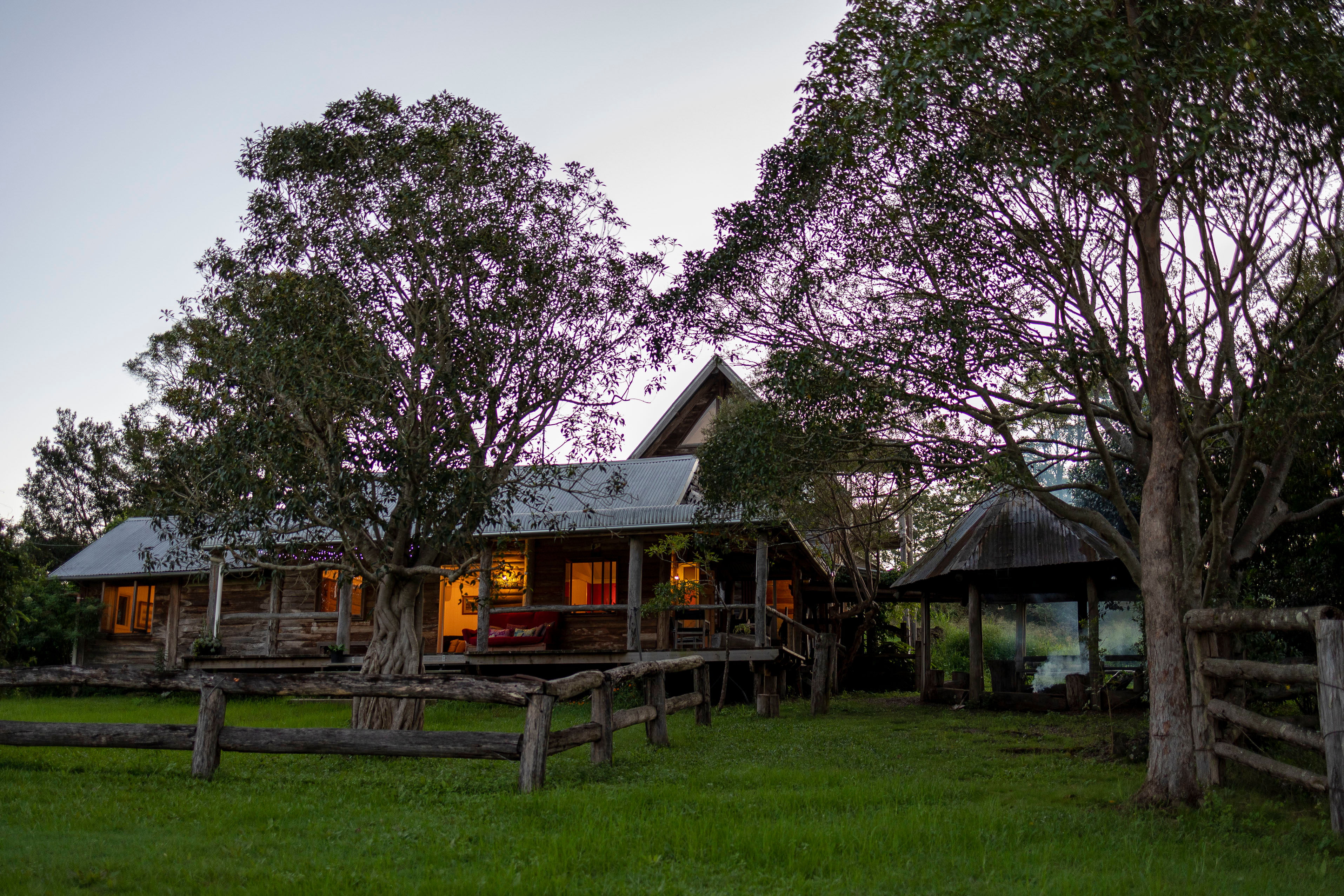 The ranch at sunset with a fire burning. 