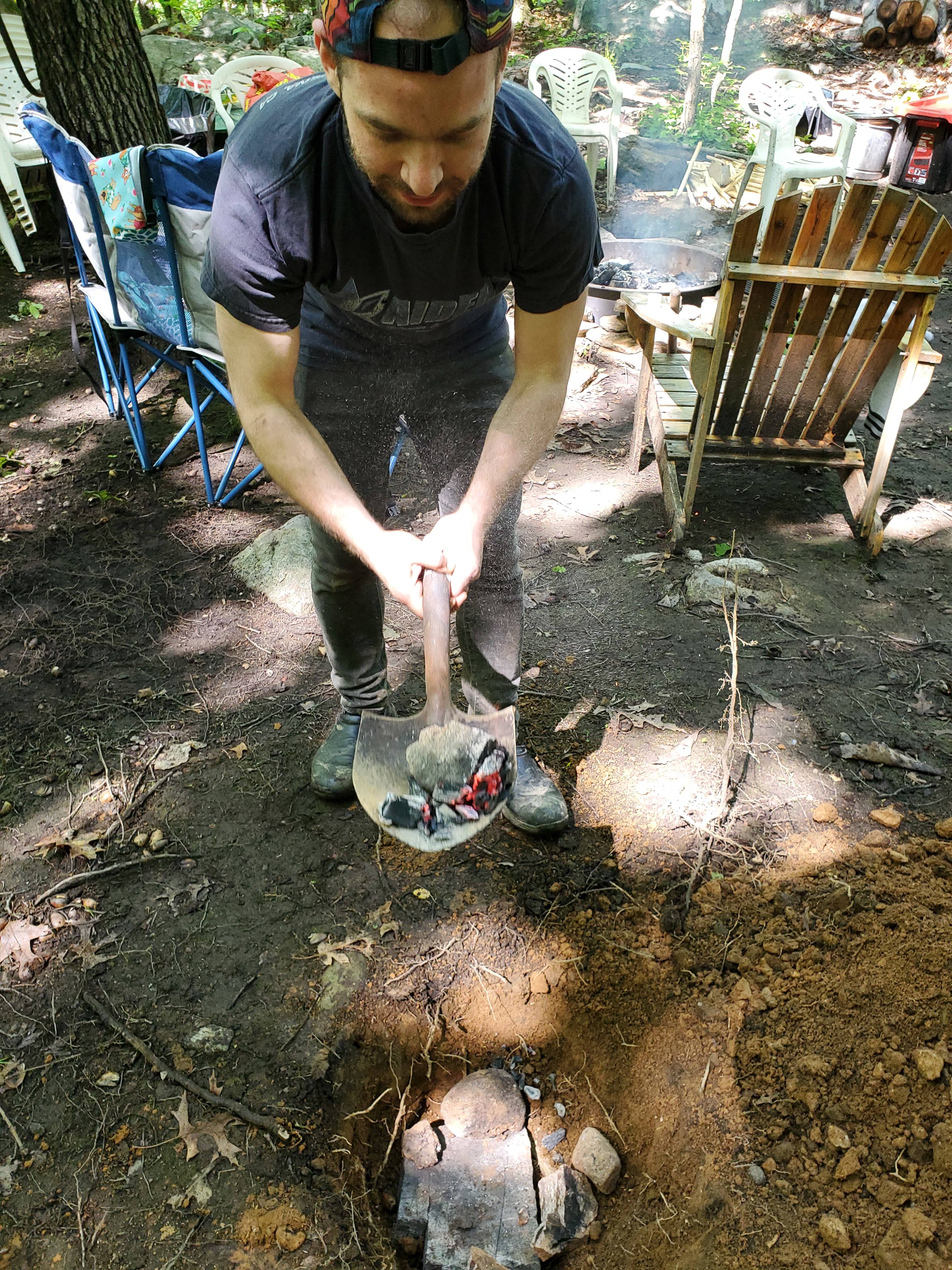 Dig a hole and fill it with hot rocks from the campfire, then place your well wrapped roast.  In this case we wrapped the pernil with banana leaves and foil.