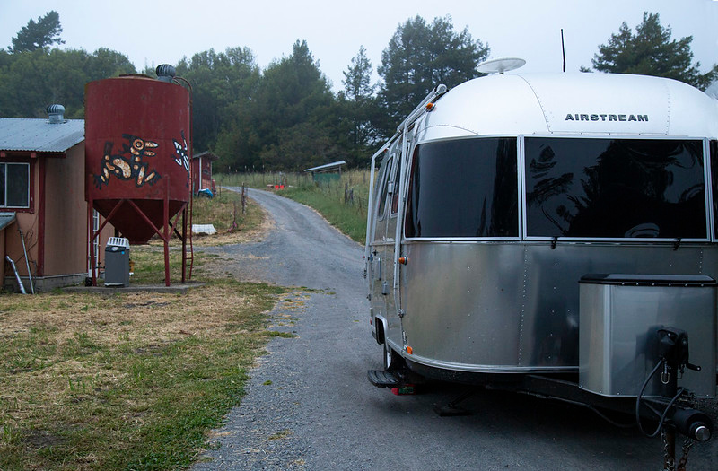 Enough room on the gravel road next to the overhang for trailer. There is road on the other side of overhang, too, so vehicles coming in do not have to drive by trailer.