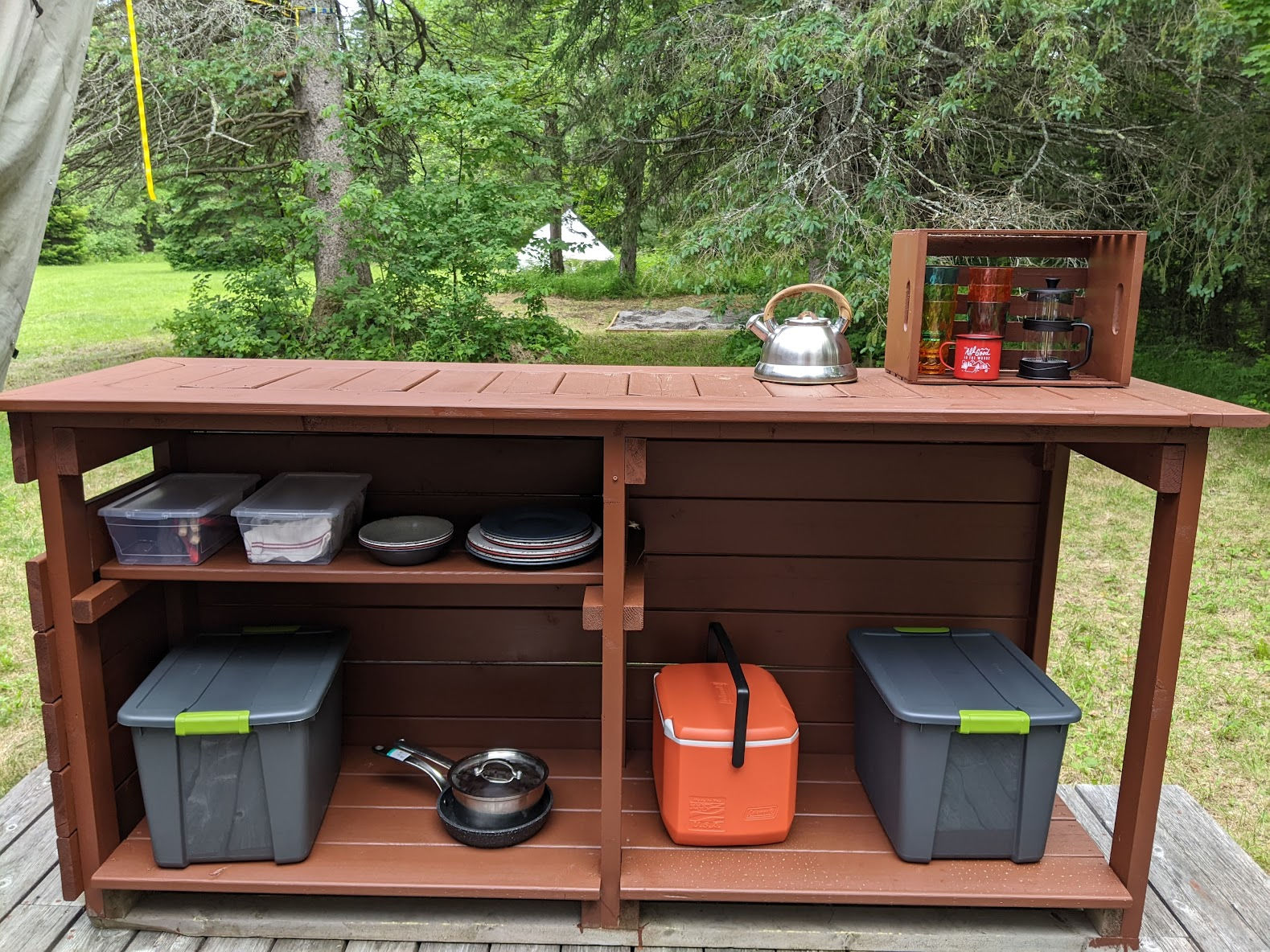 The storage cubby houses all the cooking dishes, your cooler and food storage container. 