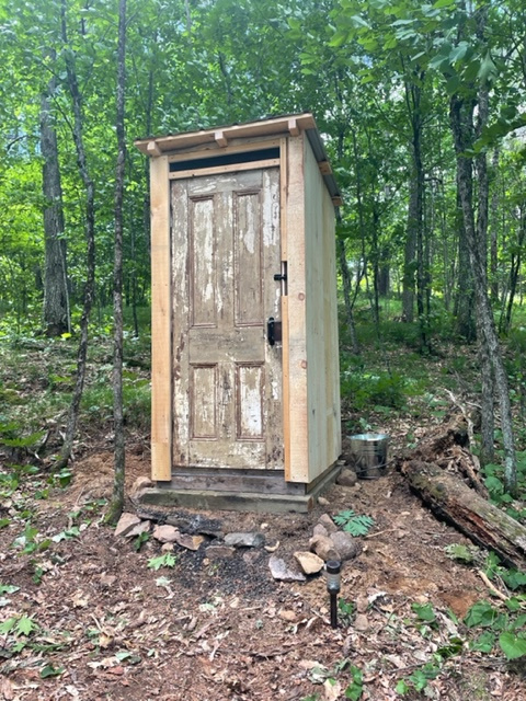The second outhouse closer to the lake.