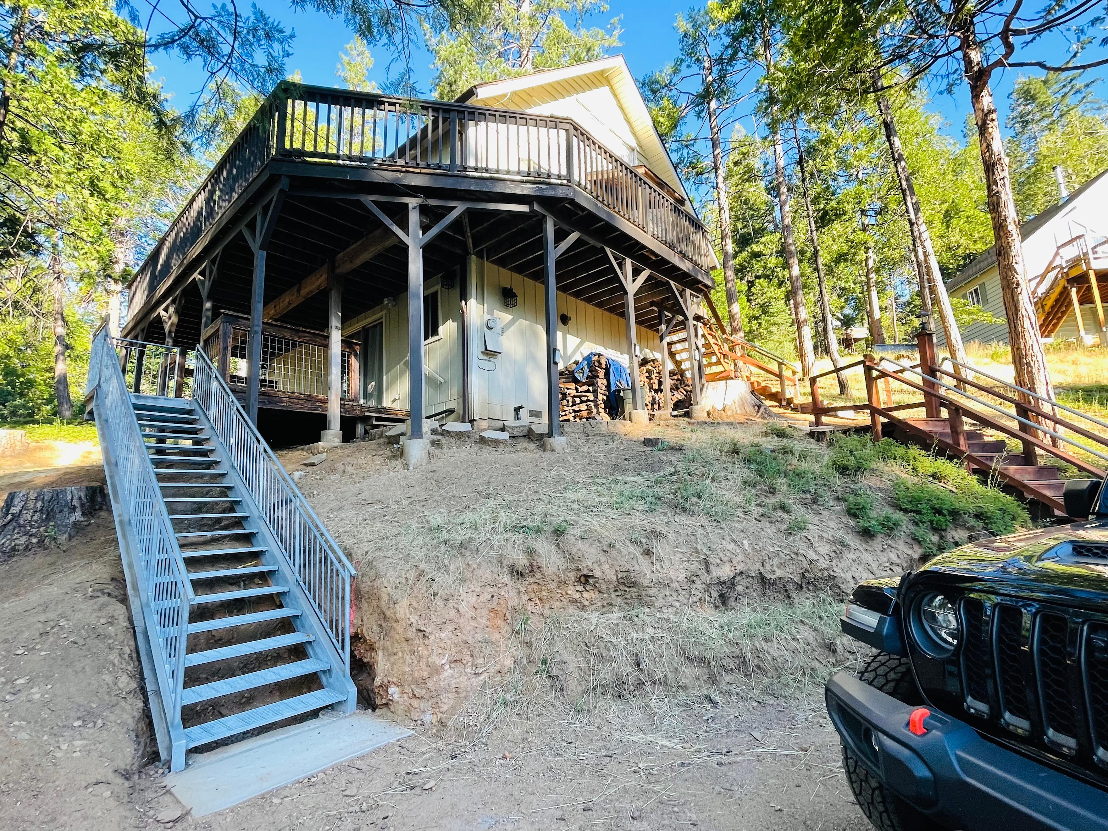 New metal stairs installed June 2022. Connects driveway to lower level deck.  