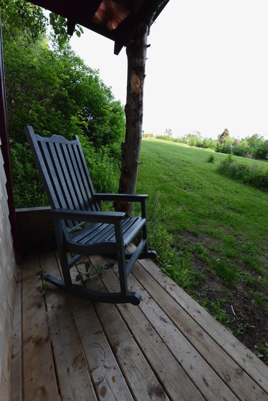 Sits on the edge of a field