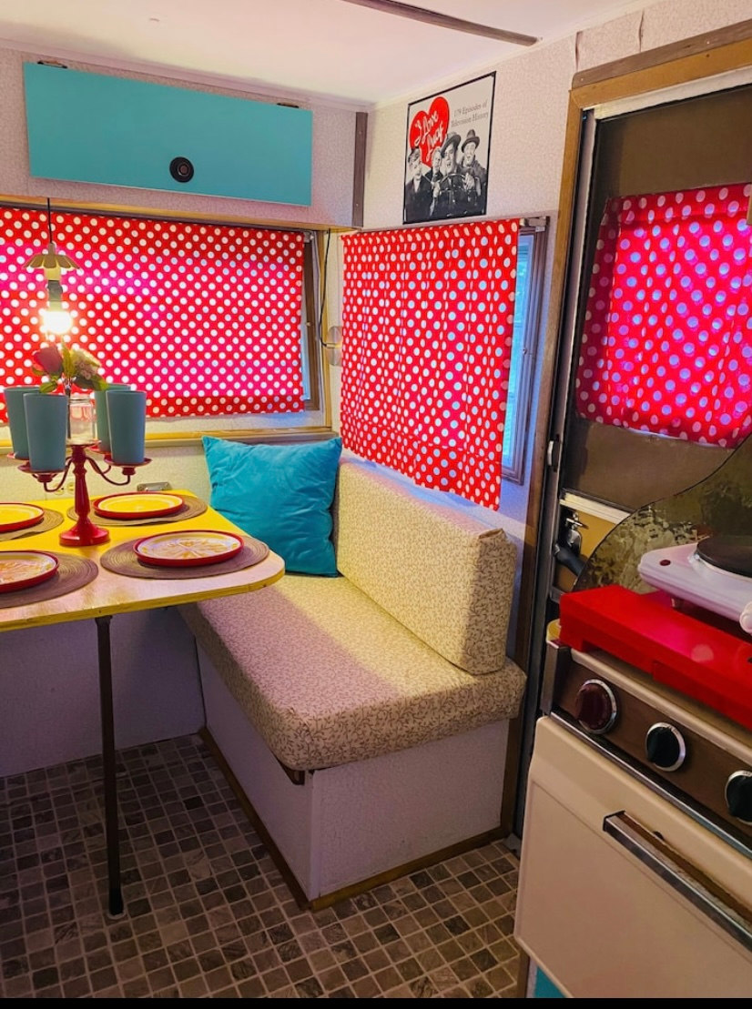 Table converts to a bed, 2 average size adults can fit.